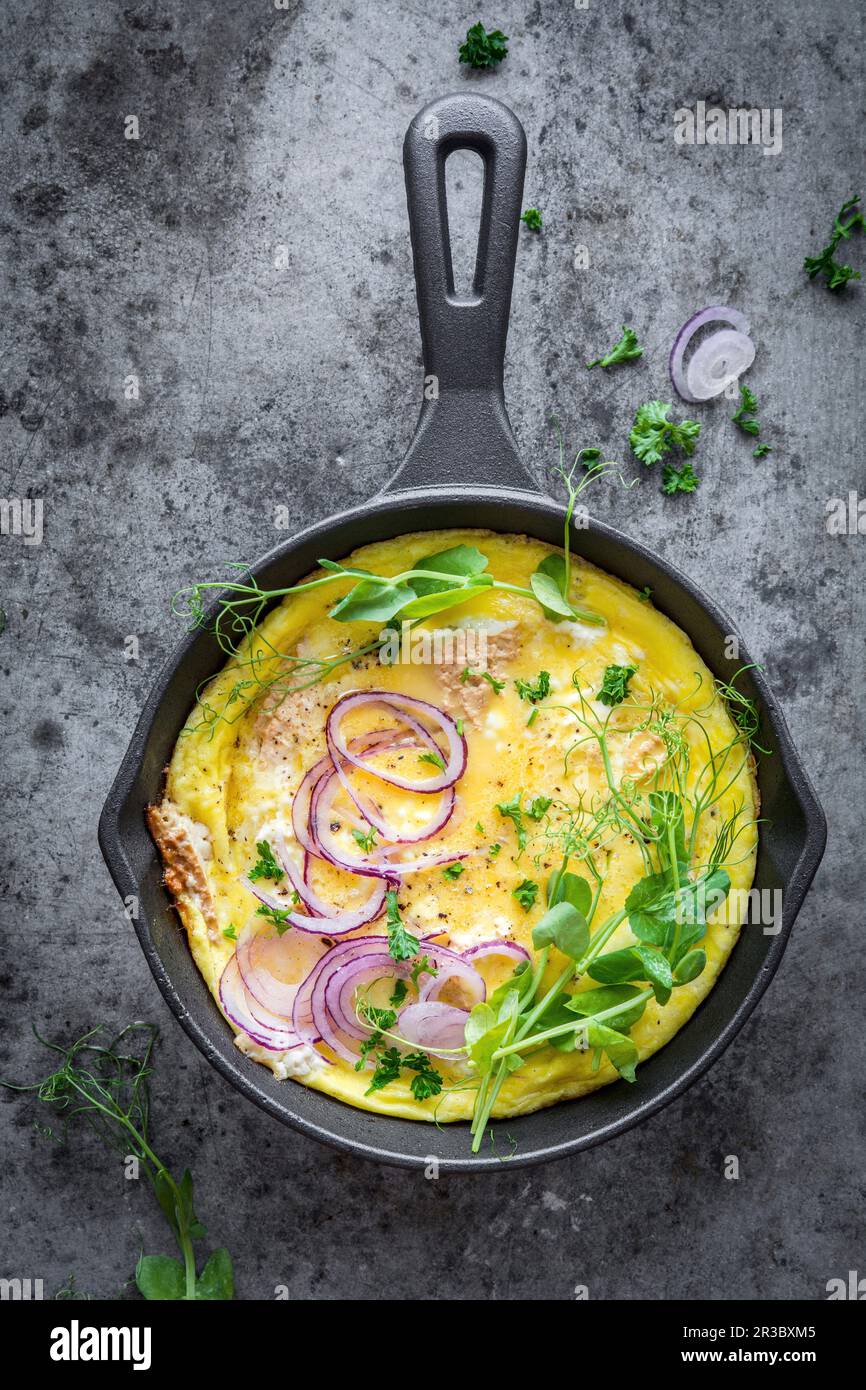 Omelette with cottage cheese, onions and pea shoots Stock Photo Alamy