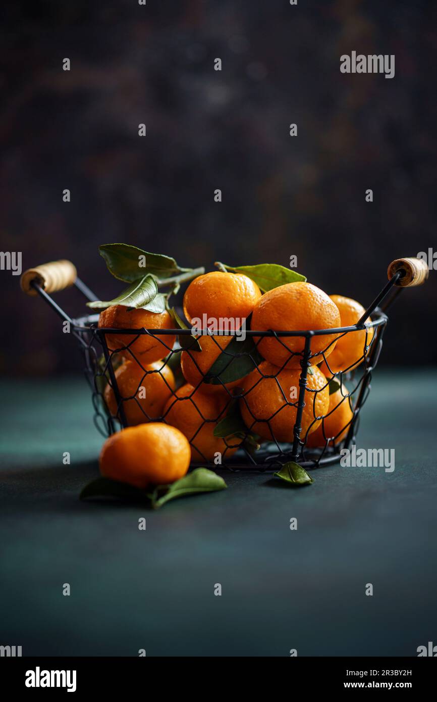 Tangerines in basket on dark Stock Photo