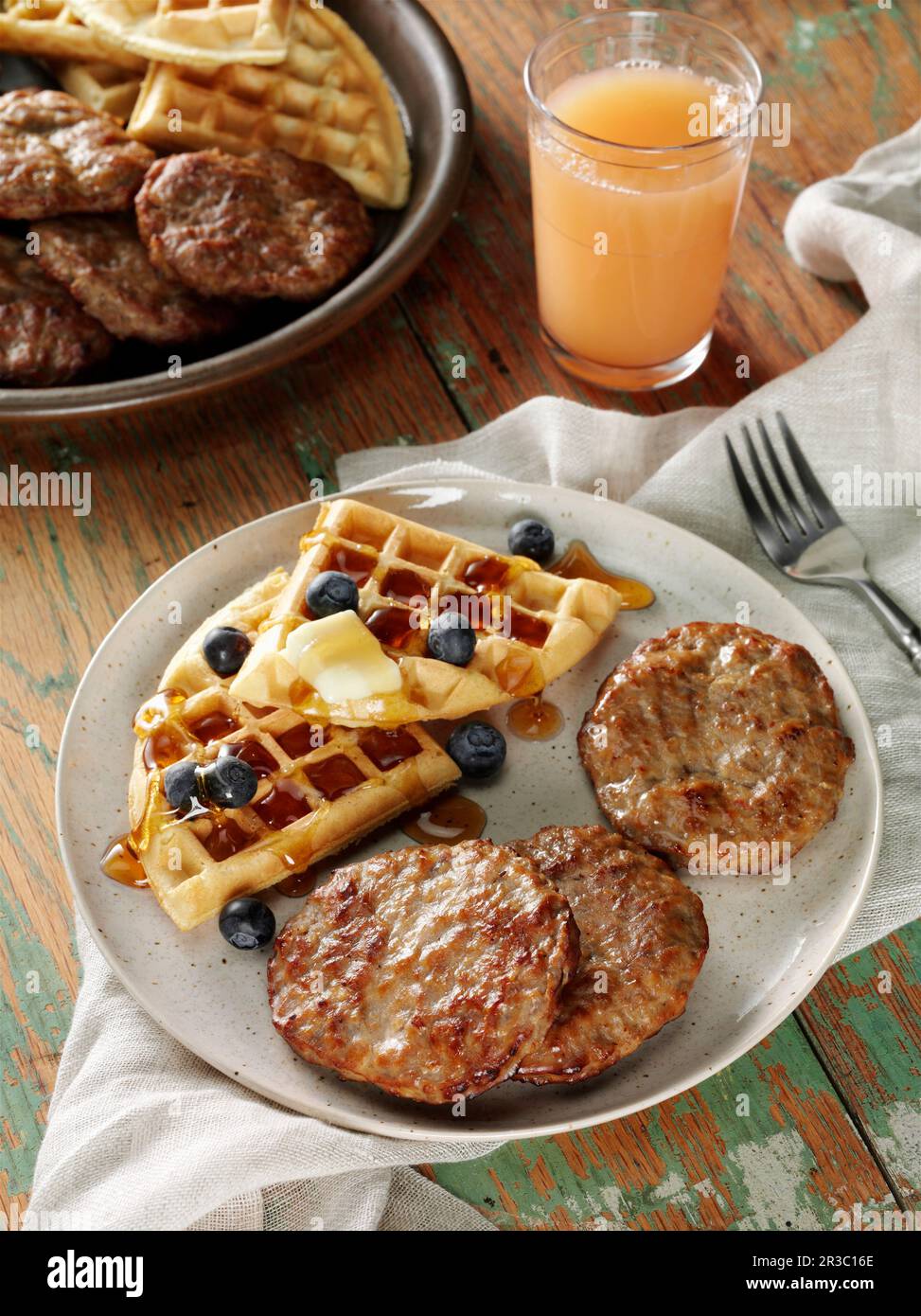 Beef breakfast sausage patties with waffles, blueberries, butter and