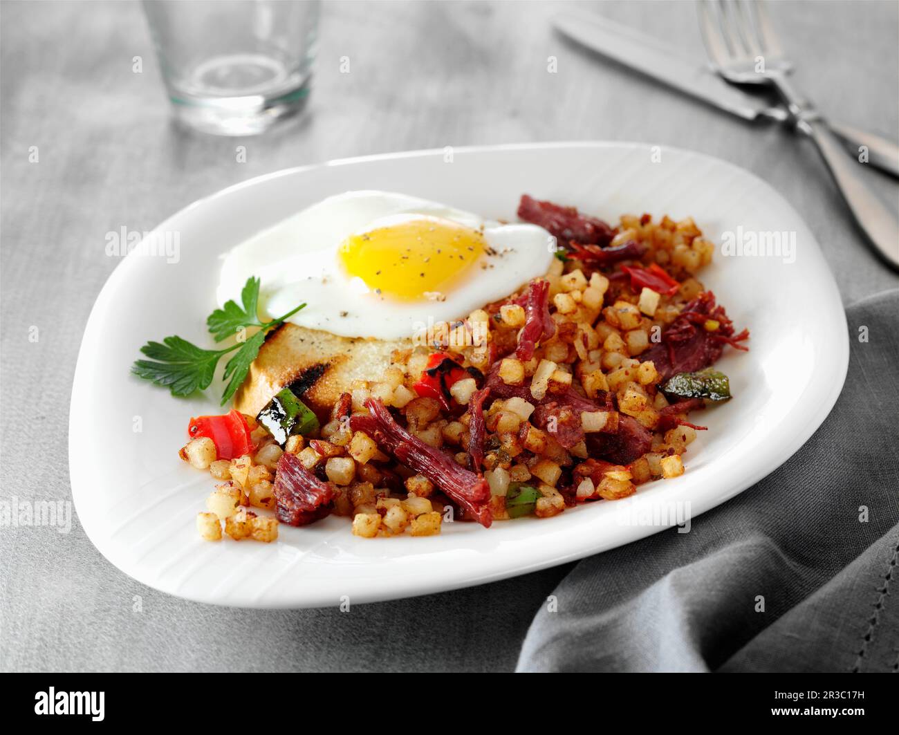 Corned beef hash with a fried egg and toast Stock Photo Alamy