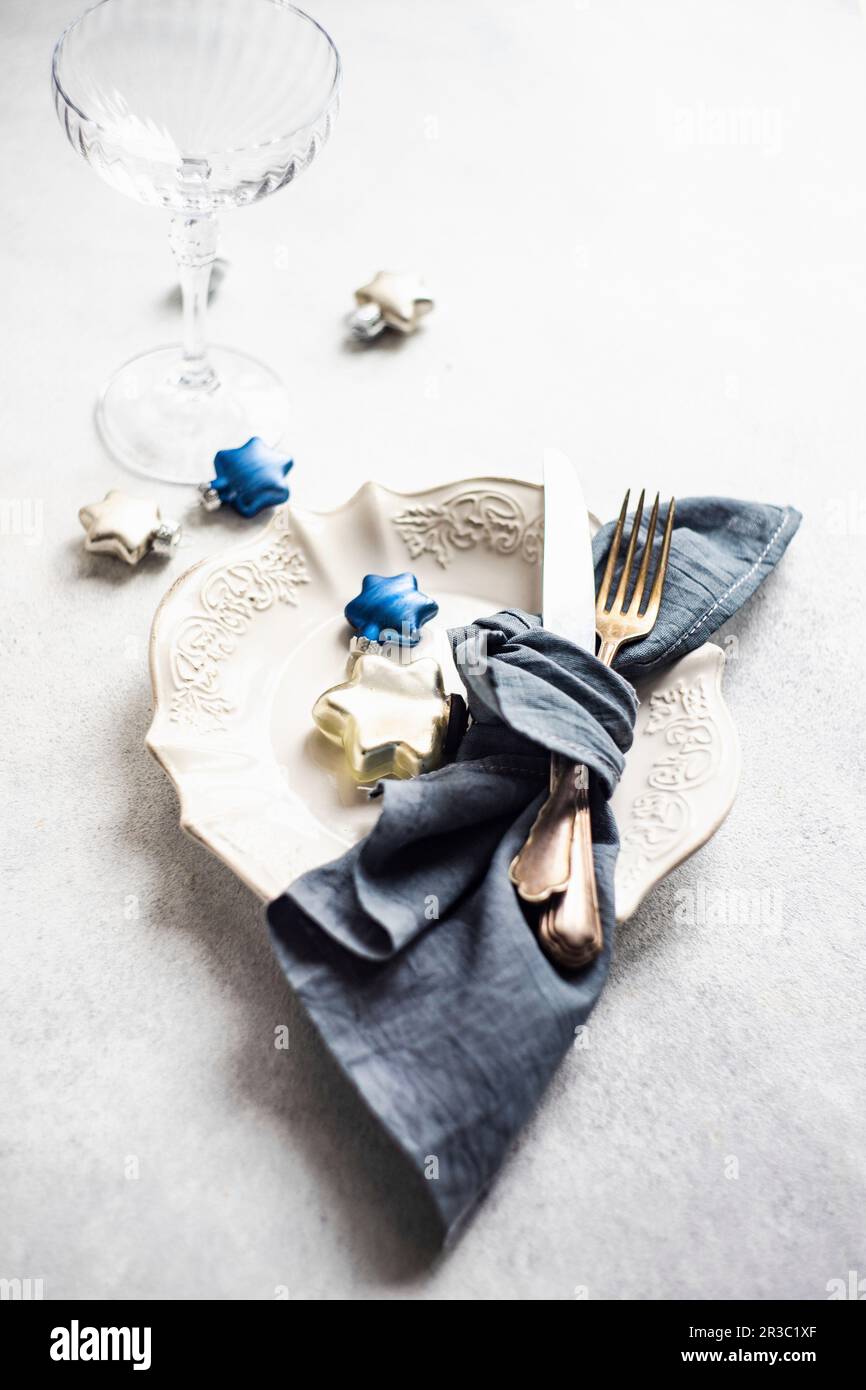 Minimalistic table setting for Christmas dinner on white concrete table Stock Photo