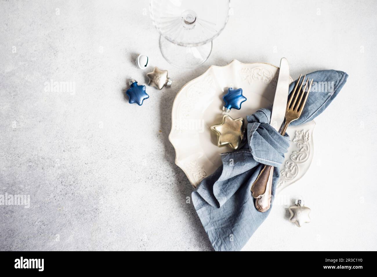 Minimalistic table setting for Christmas dinner on white concrete table Stock Photo