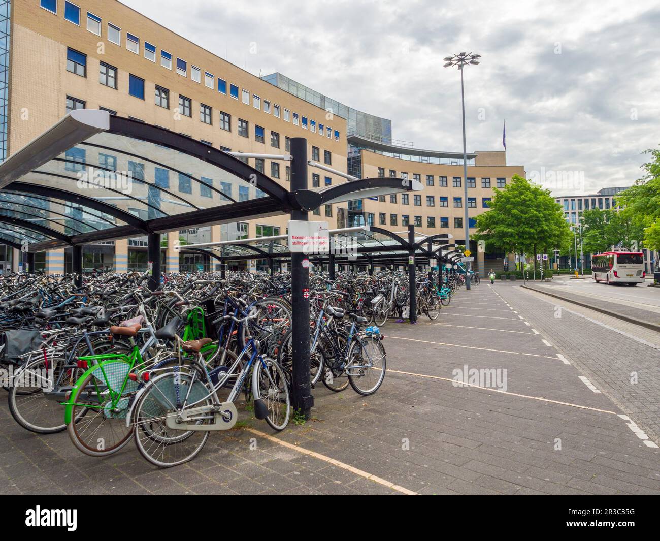 Hundreds of bicycles parked up under a shelter outside Amersfoort Central railway station, Netherlands, Europe. Stock Photo