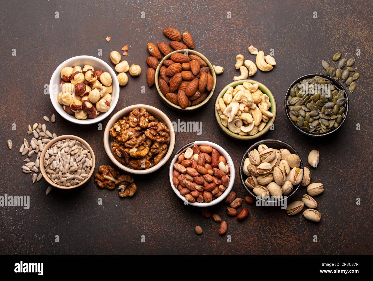 Assorted nuts and various seeds in bowls Stock Photo