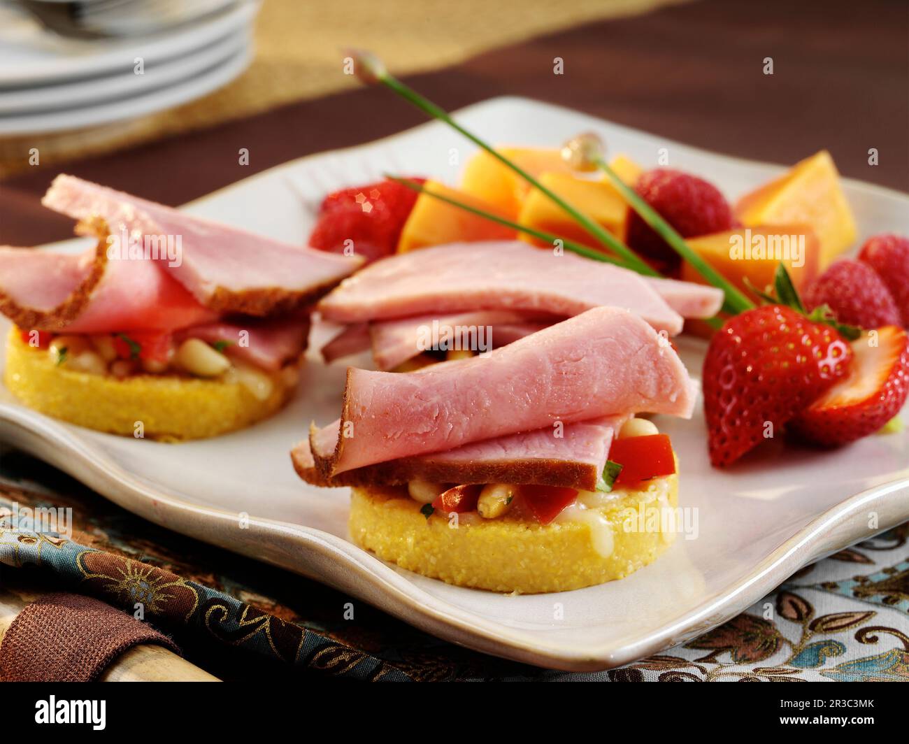 Ham crostini appetizers with tomato, vegetables and mozzarella cheese