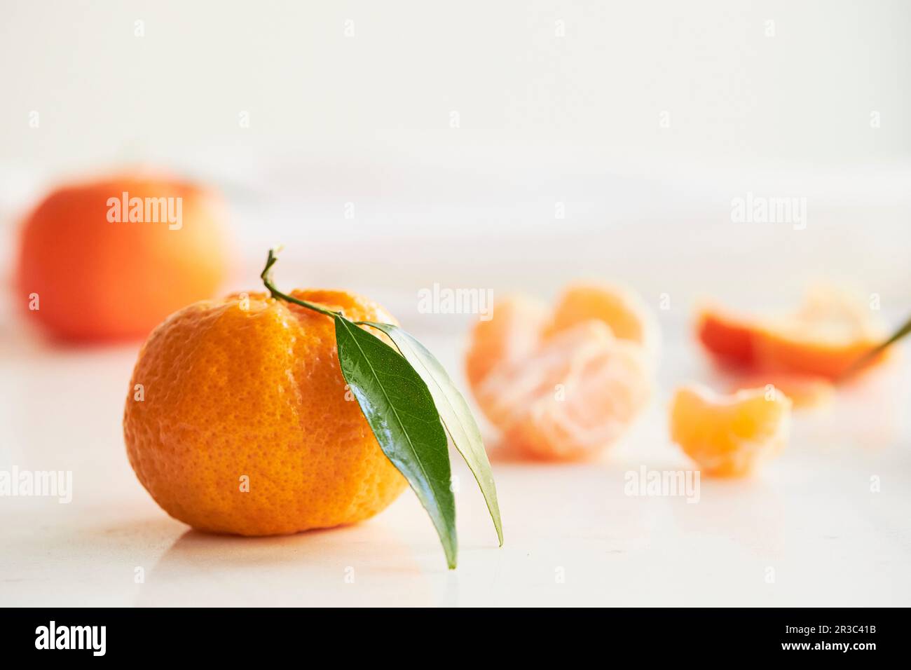 Whole tangerine and peeled pieces Stock Photo Alamy