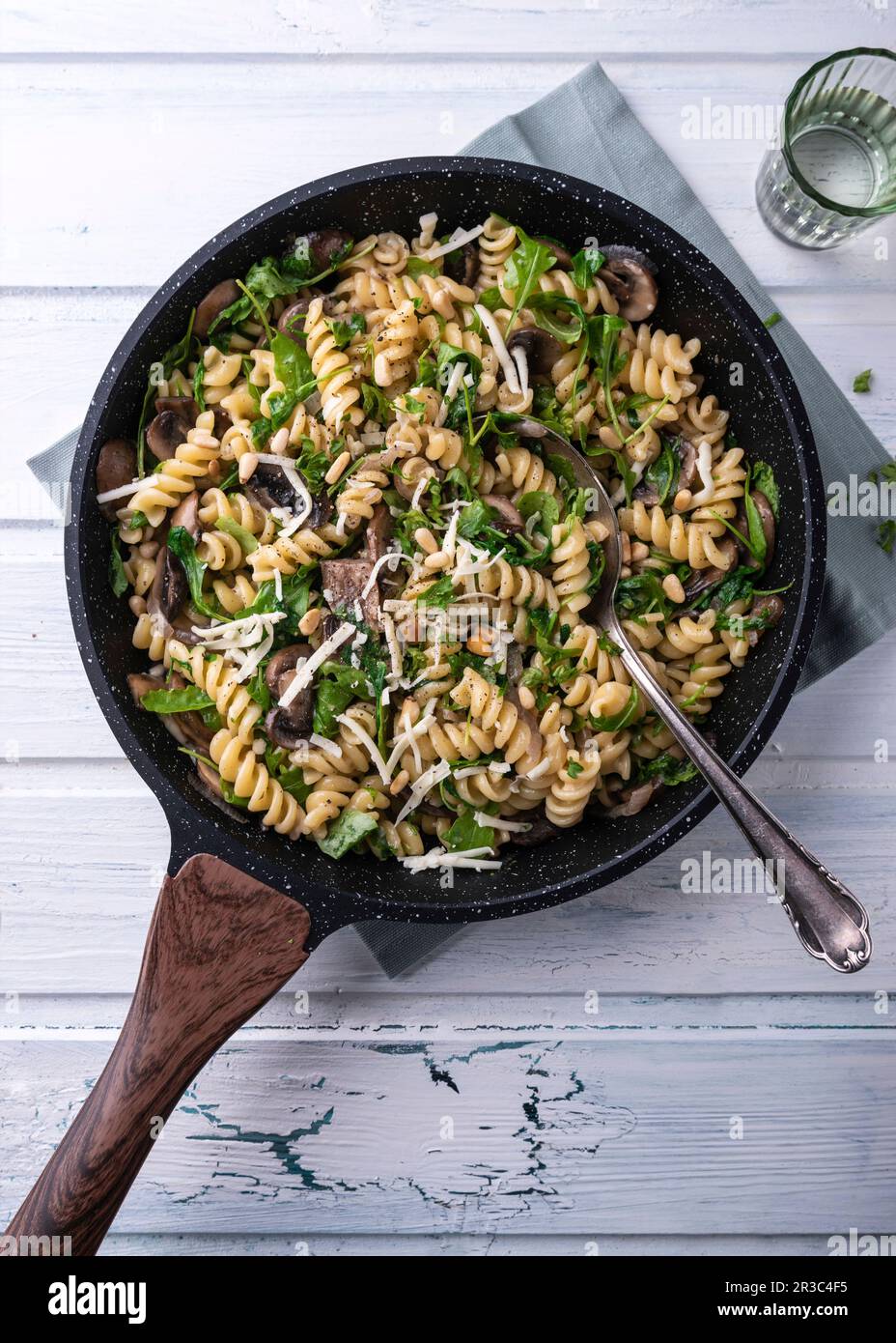 Vegan mushroom and rocket pasta with pine nuts and almond cheese Stock Photo