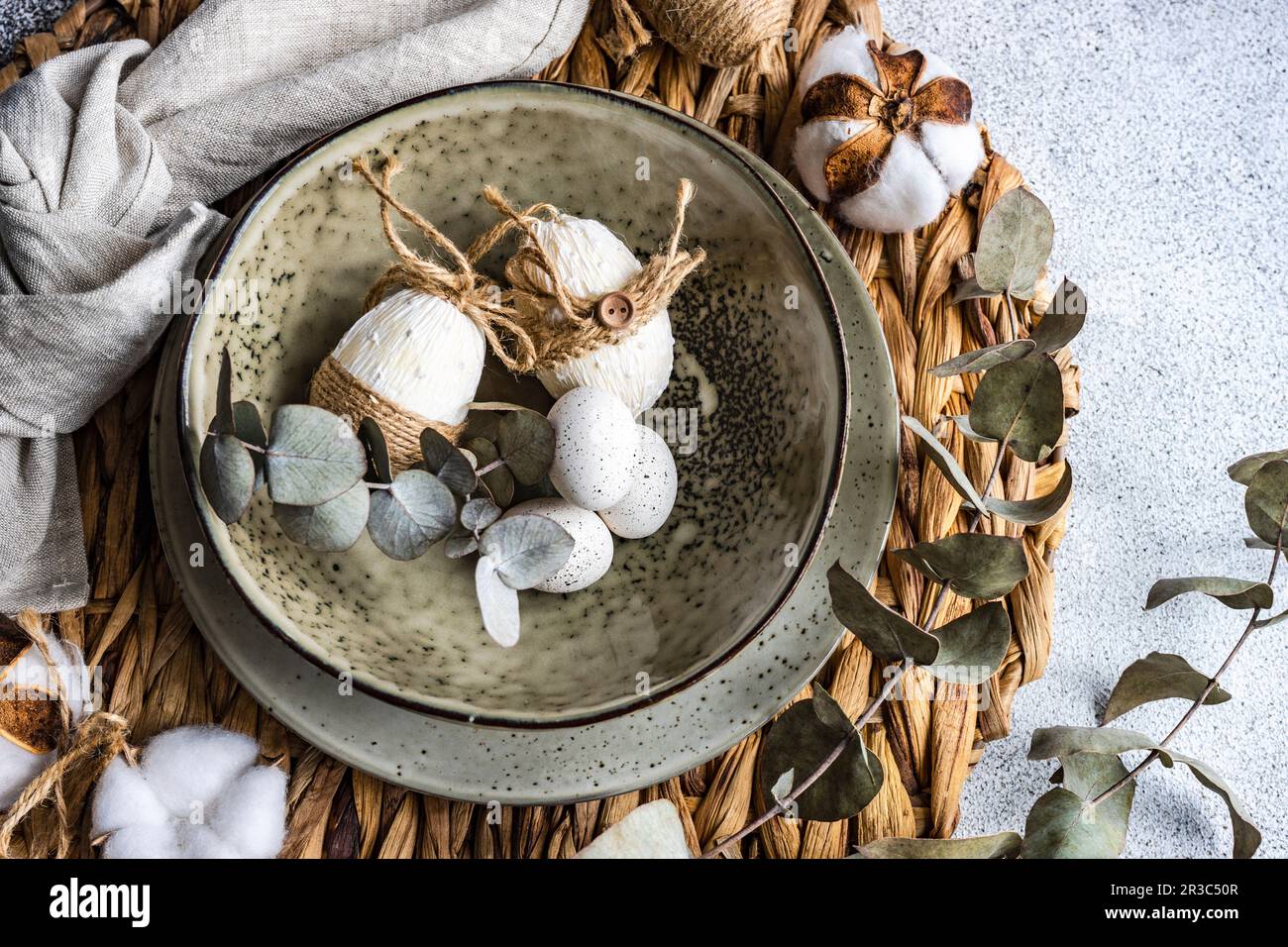 Easter festive table setting with tiny eggs and tableware on stone background Stock Photo