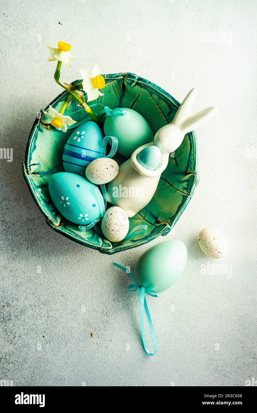 Easter frame concept with daffodils and eggs on concrete background Stock Photo