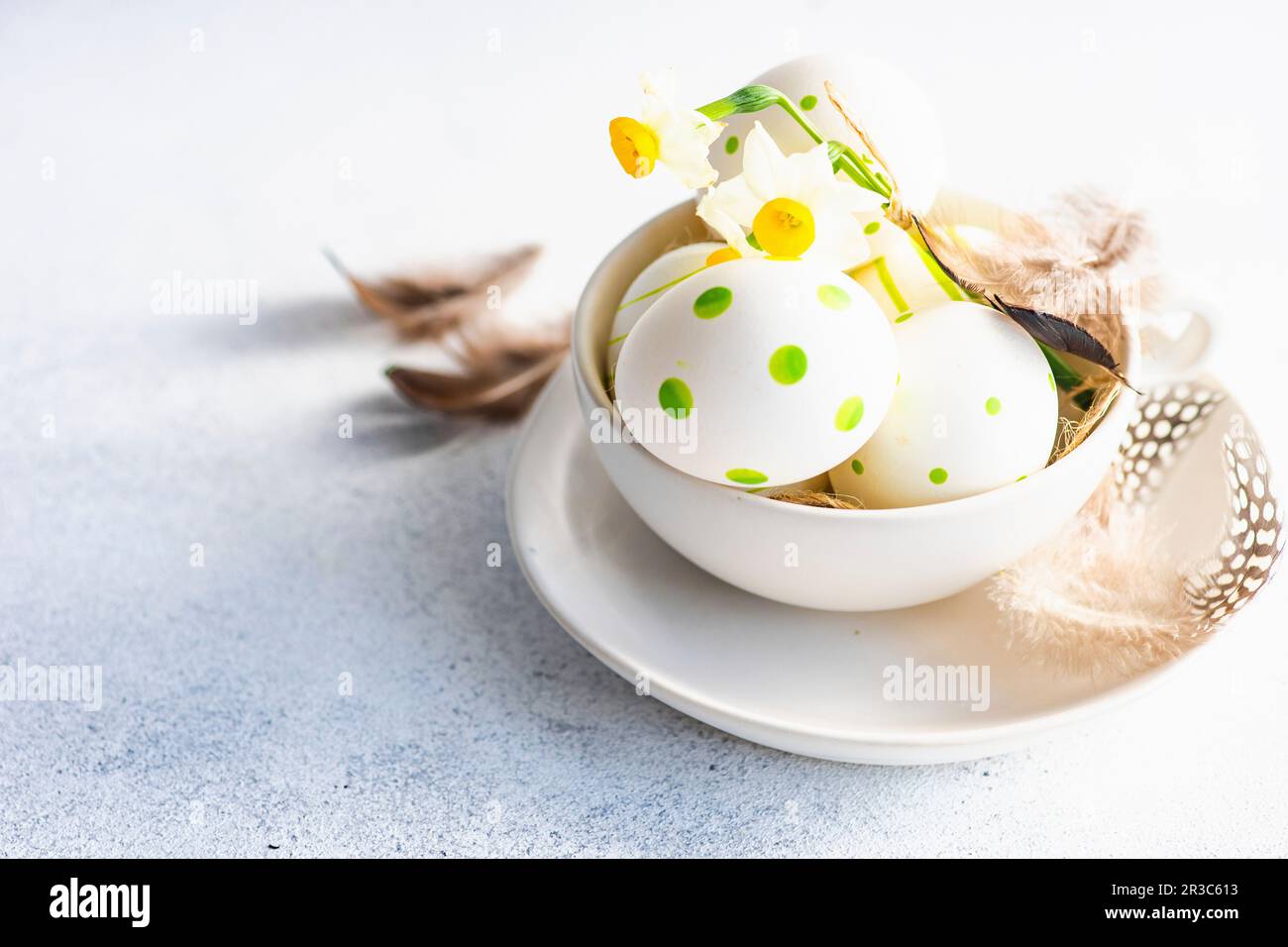 Easter frame concept with daffodils and eggs on concrete background Stock Photo