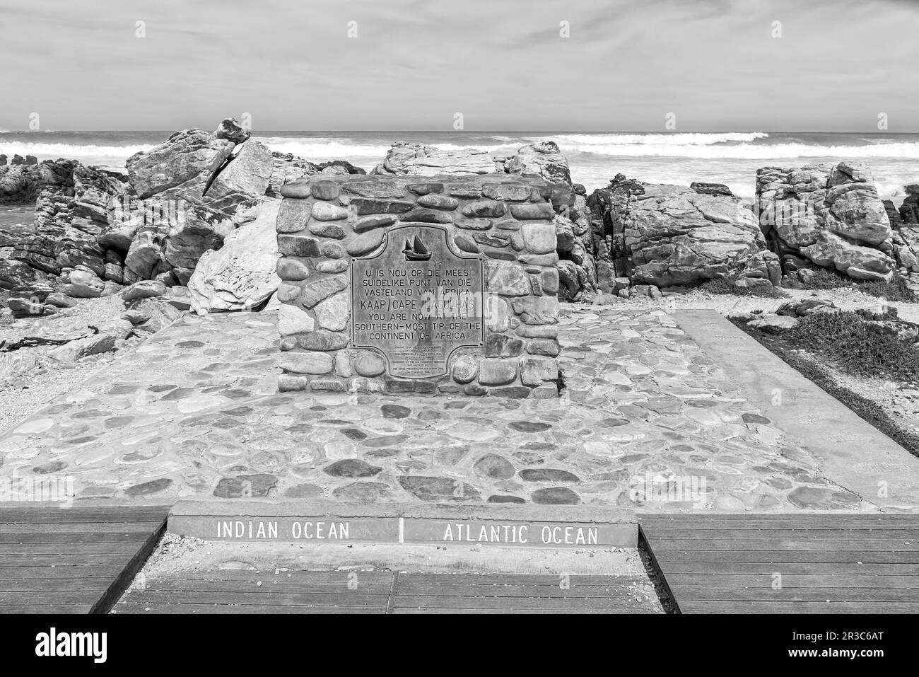 Agulhas National Park, South Africa - Sep 21, 2022: Plaque at the southern-most tip of Africa, also the point where the Atlantic and Indian Oceans mee Stock Photo