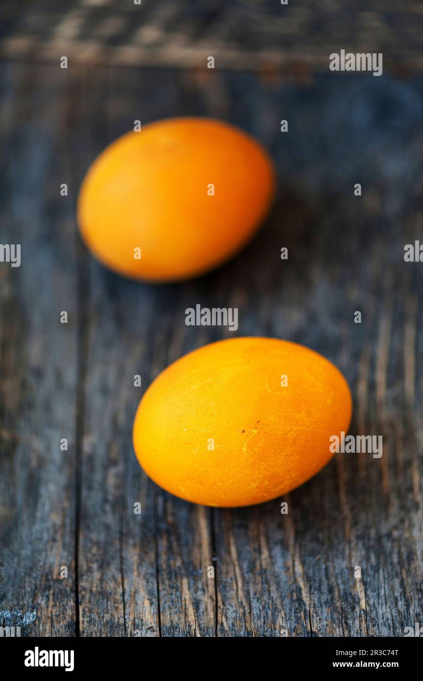 Yellow Easter eggs on a wooden background Stock Photo