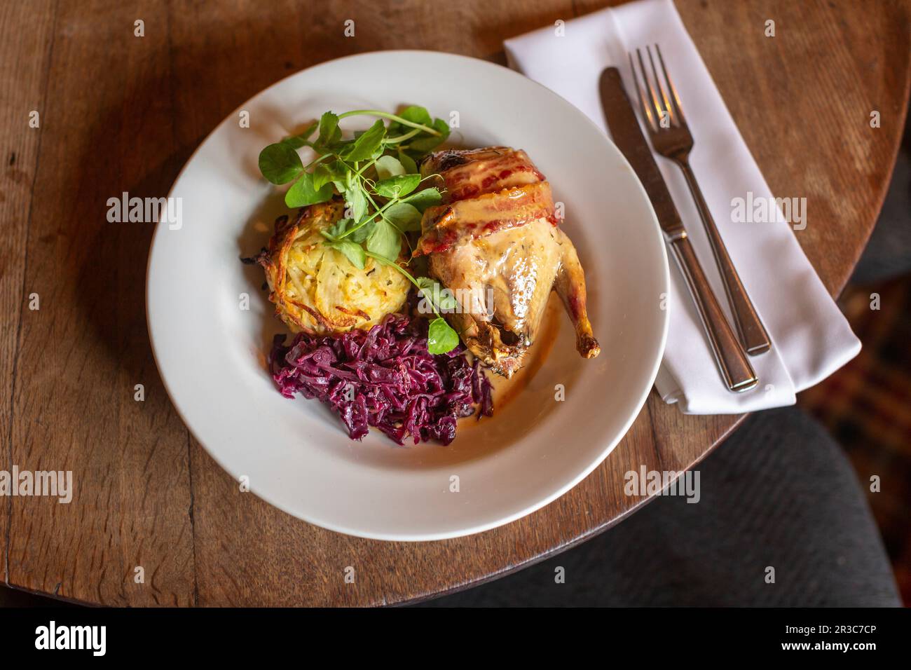 Roasted pheasant with bacon, gravy, potato rösti, red cabbage and pea