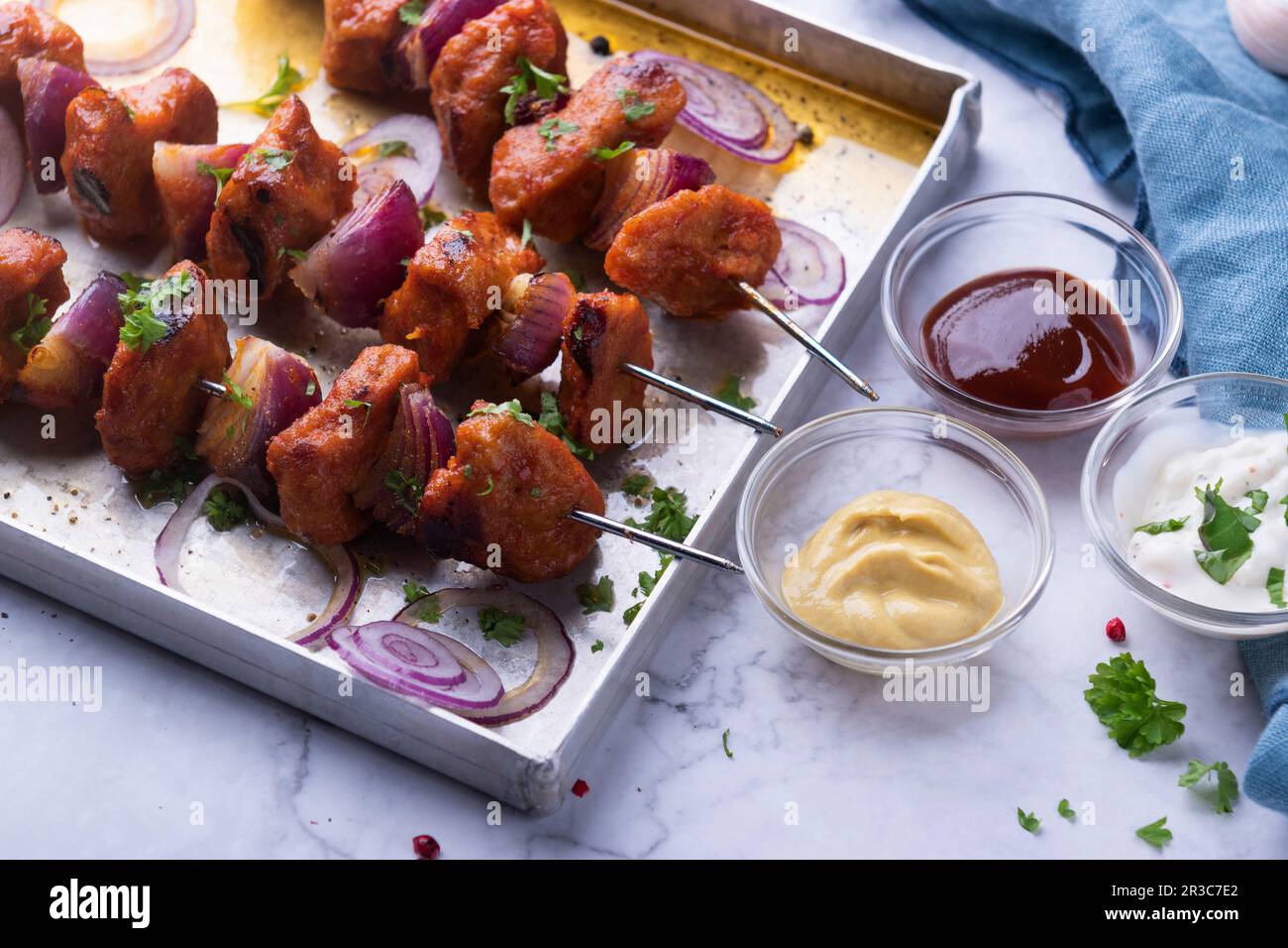 Spicy seitan and onion skewers with three different dips, vegan Stock