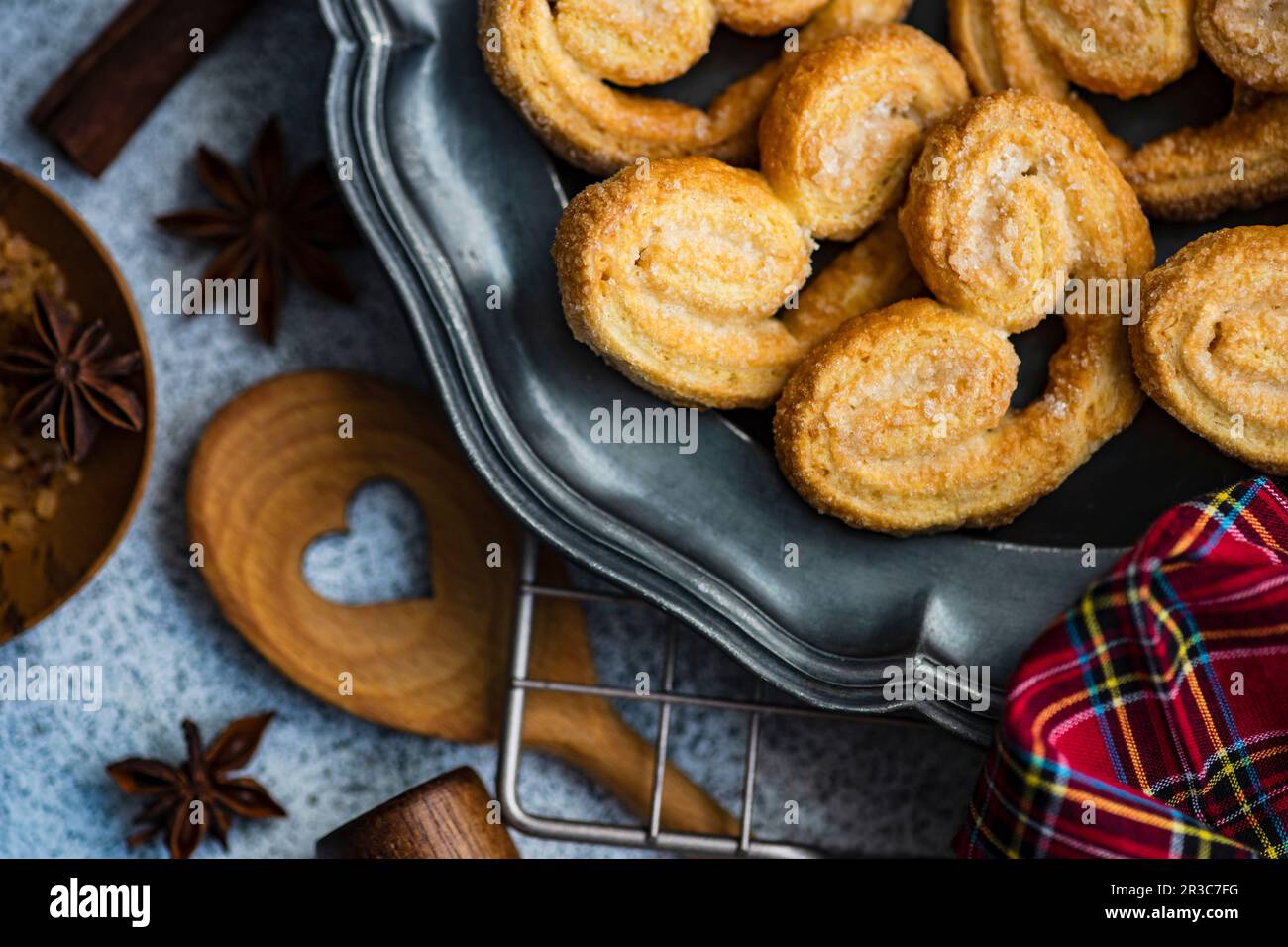 Traditional Puff pastry spiral biscuits known as a pig s ears on plate