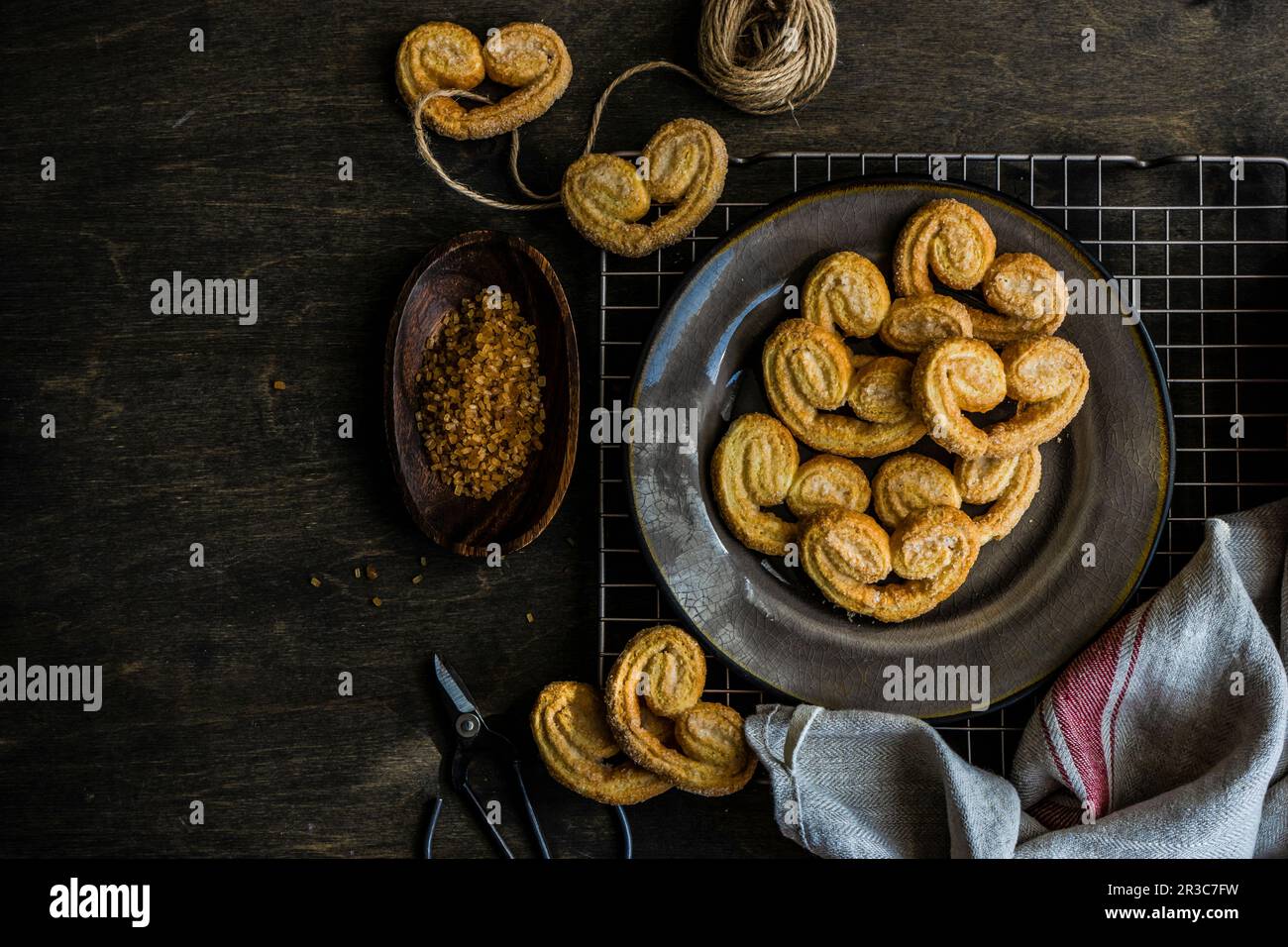Traditional Puff pastry spiral biscuits known as a pig s ears on plate