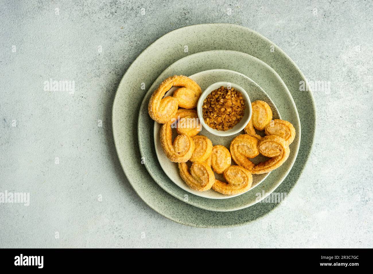 Traditional Puff pastry spiral biscuits known as a pig s ears on plate