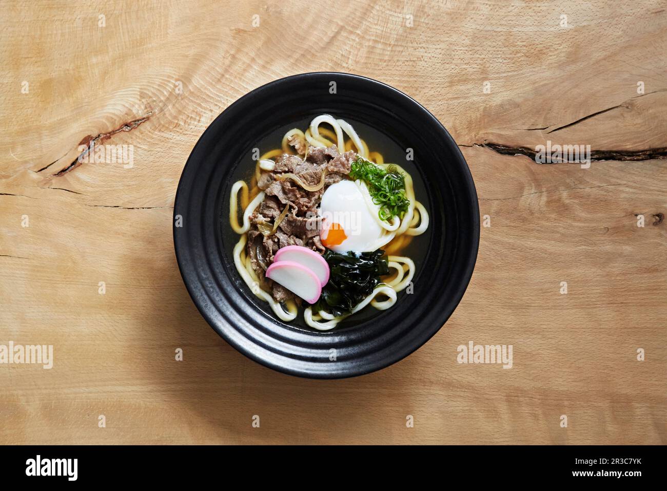 Ramen with udon noodles, shredded beef, seaweed and an egg Stock Photo