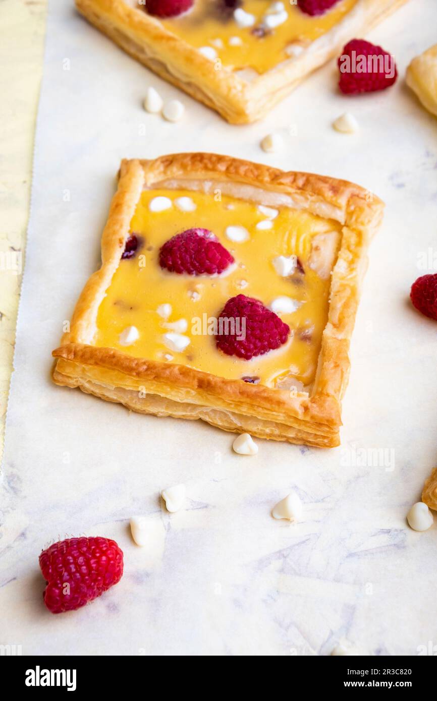 Raspberry, white chocolate and custard tarts Stock Photo