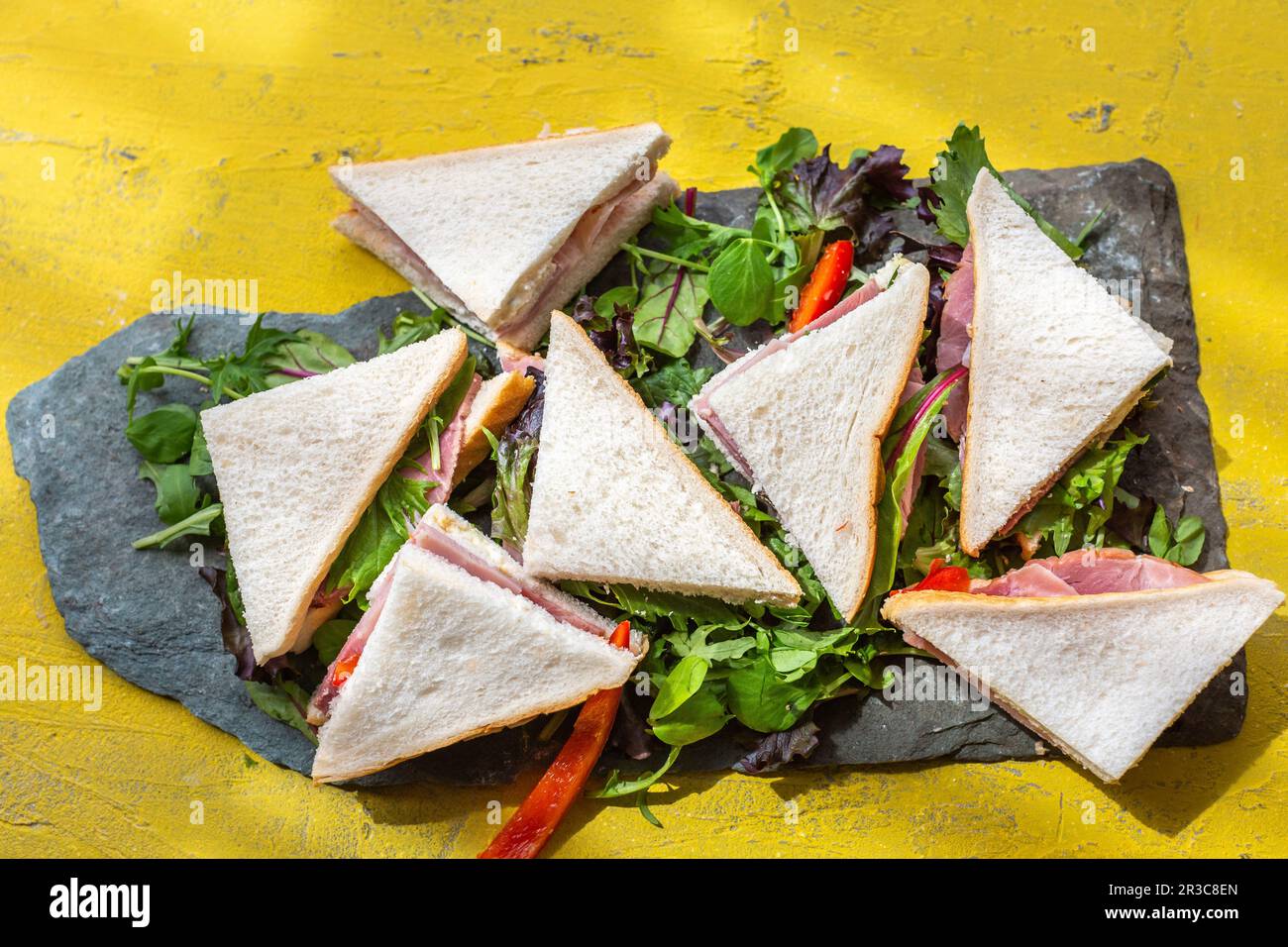 Sandwich corners with ham on lettuce leaves Stock Photo Alamy