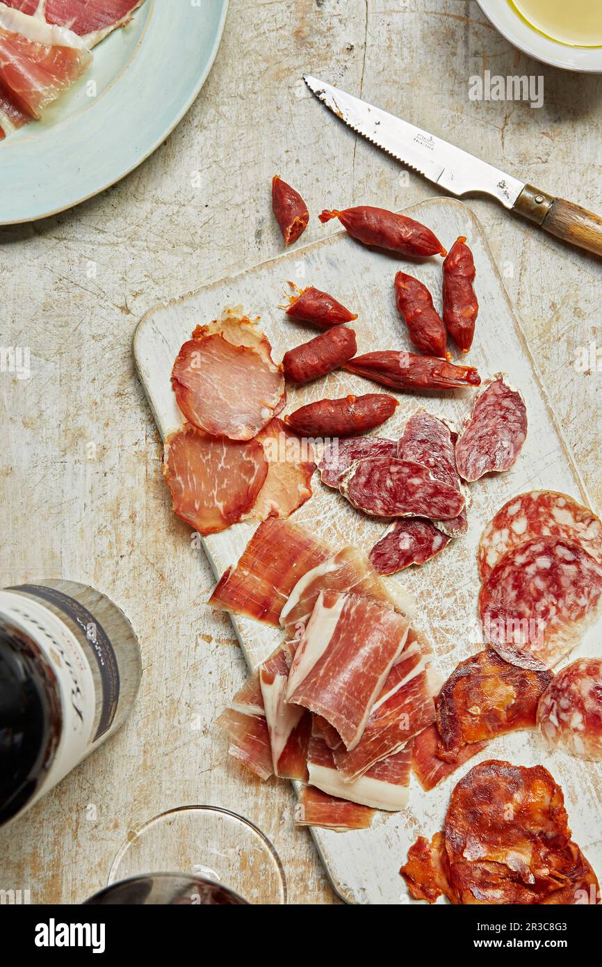 Selection of cured meats on a charcuterie board Stock Photo Alamy