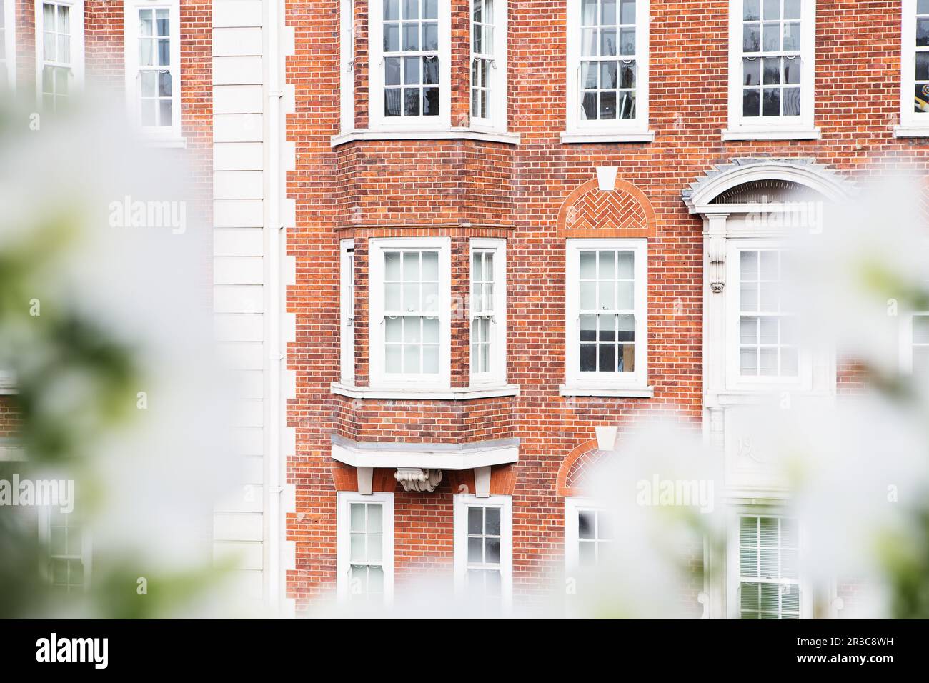 White vintage wooden windows on a restored red brick wall Stock Photo ...