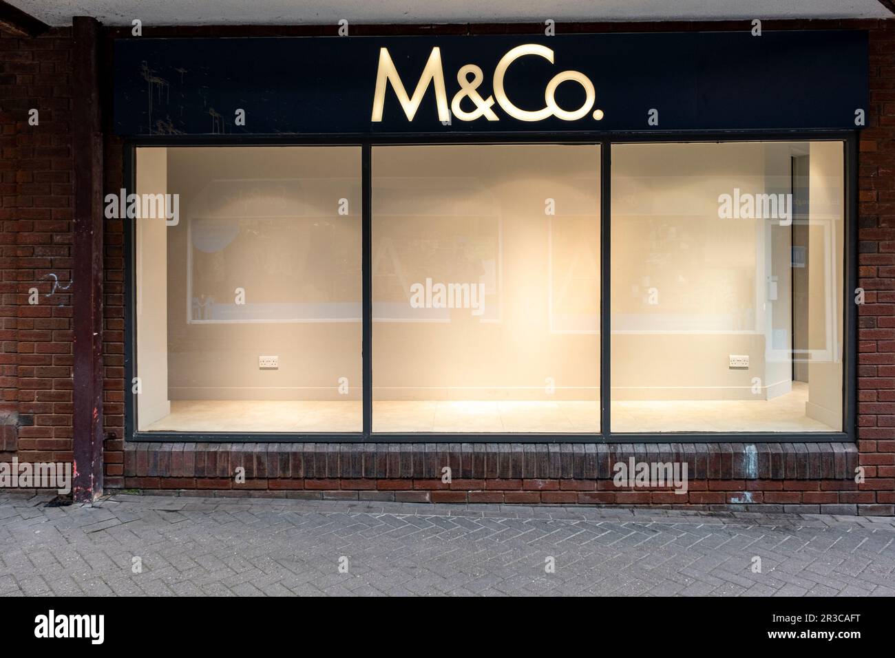 Empty M&Co shop window after closing down UK Stock Photo