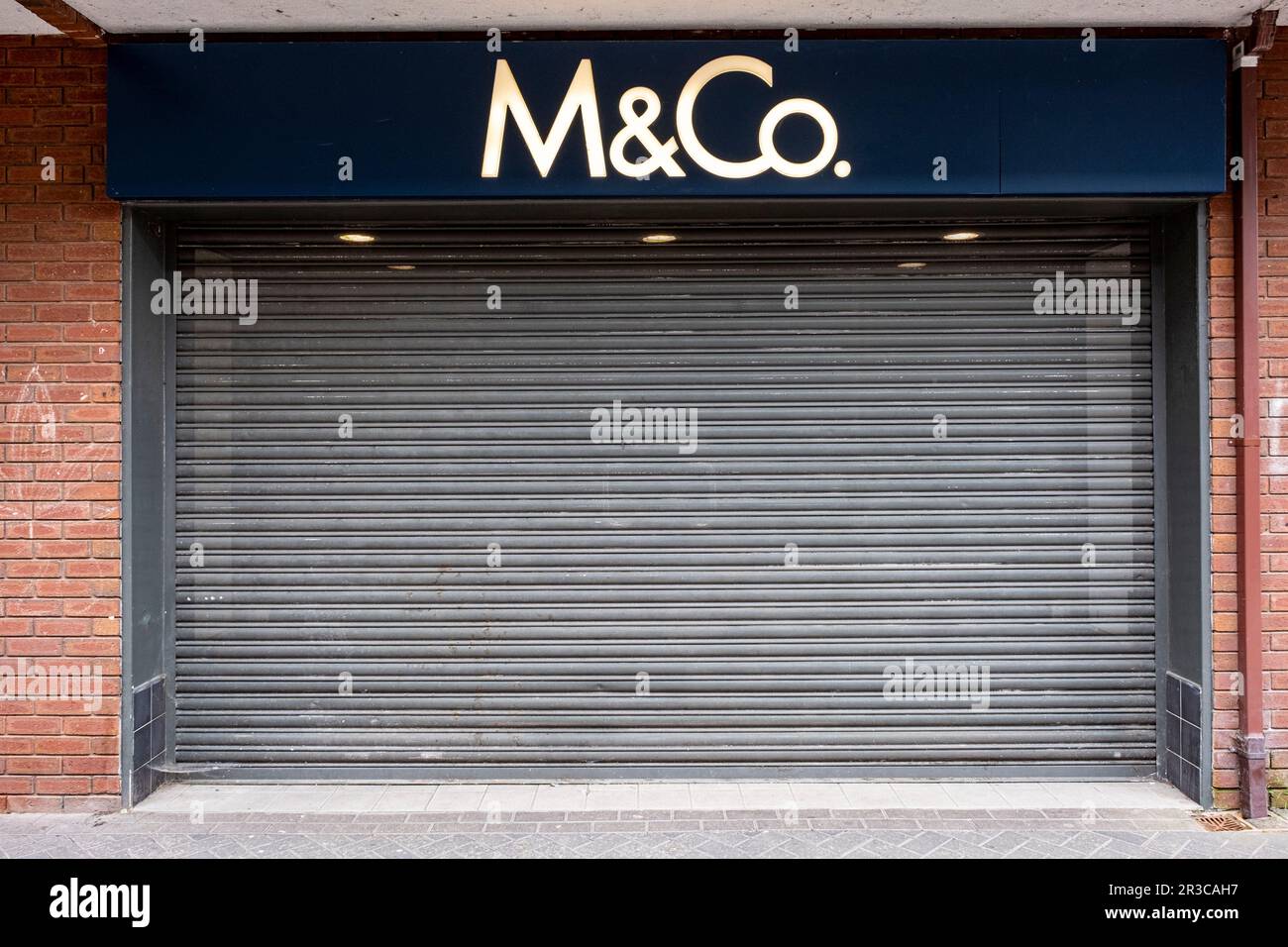 Closed down and shuttered M&Co clothes shop, UK Stock Photo