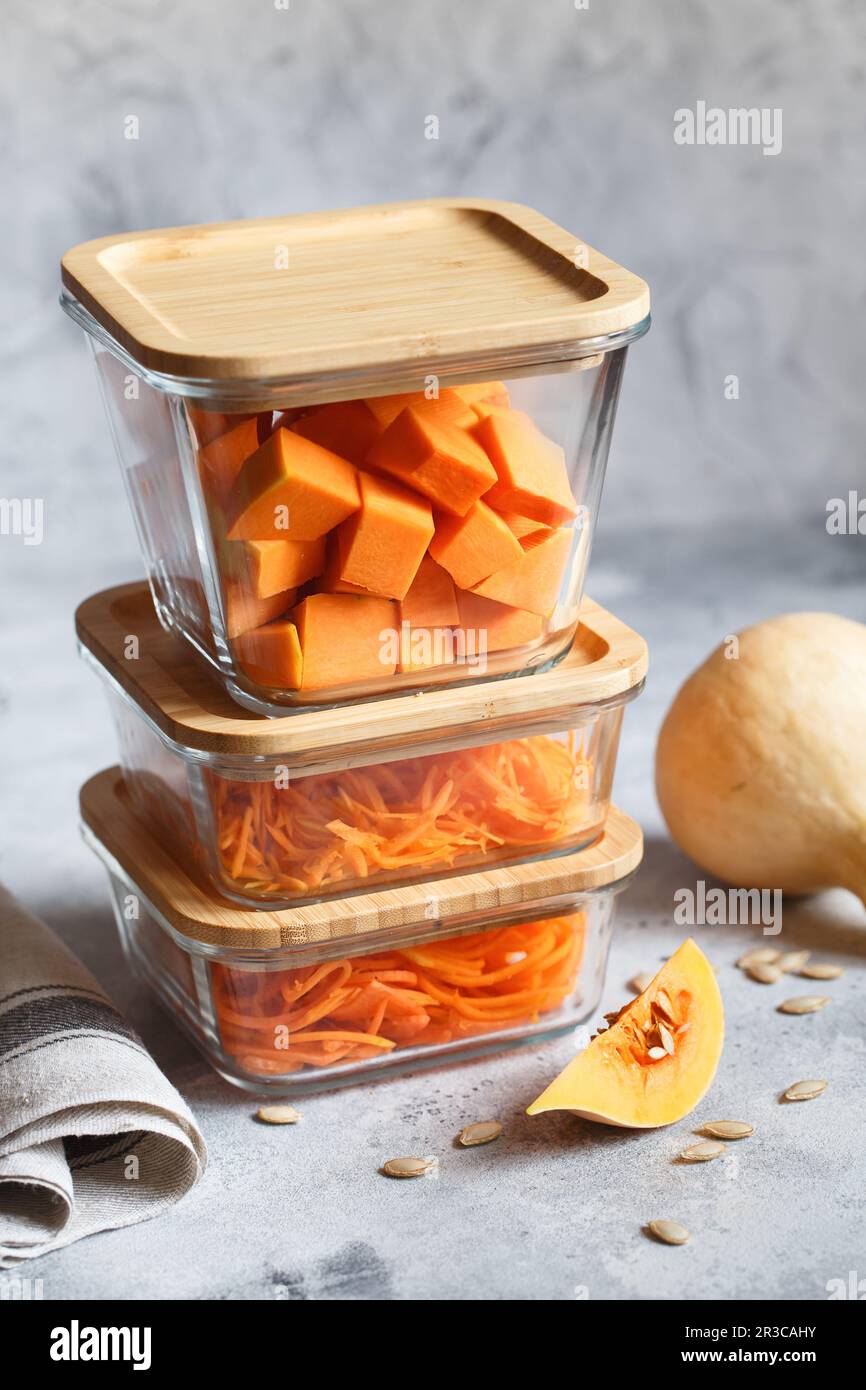 Glass boxes with fresh raw orange vegetables. Finaly shredded pumpkin and big pieces. Healthy Meal P Stock Photo