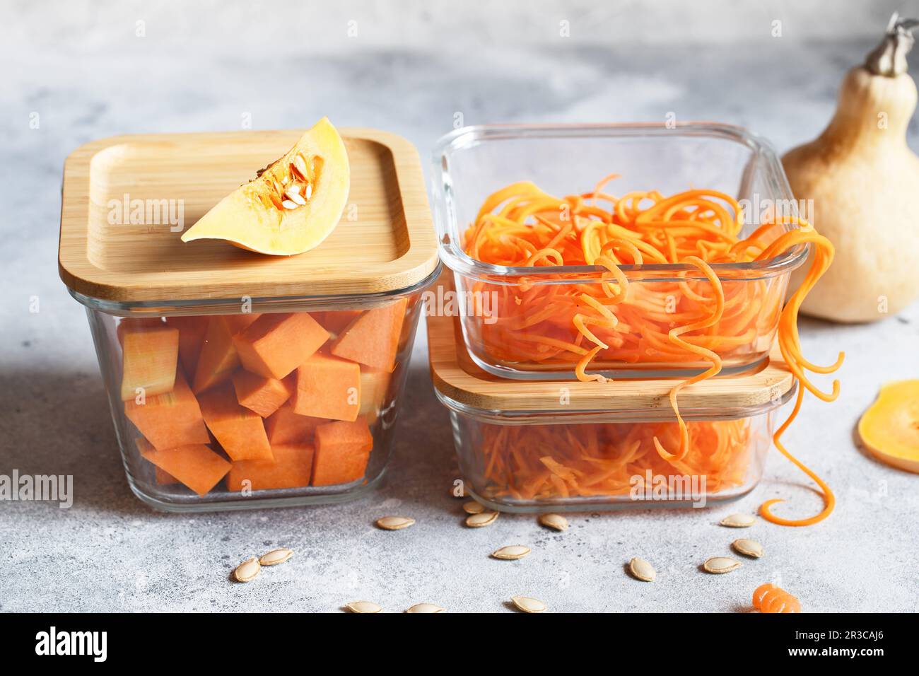Glass boxes with fresh raw orange vegetables. Finaly shredded pumpkin and big pieces. Healthy Meal P Stock Photo