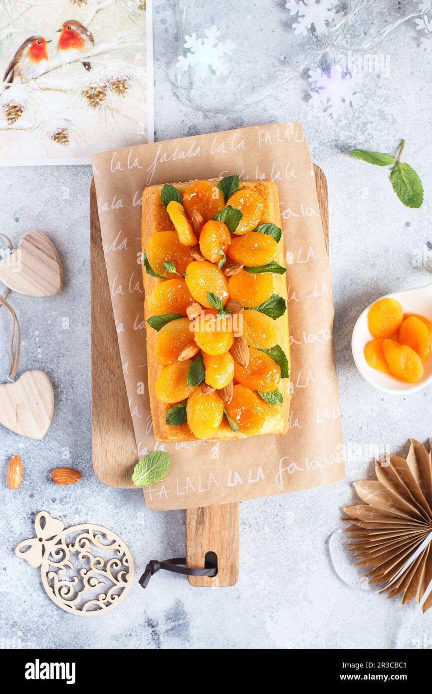 Orange Pound Cake flavored with freshly squeezed orange juice and zest decorated with dried apricots Stock Photo