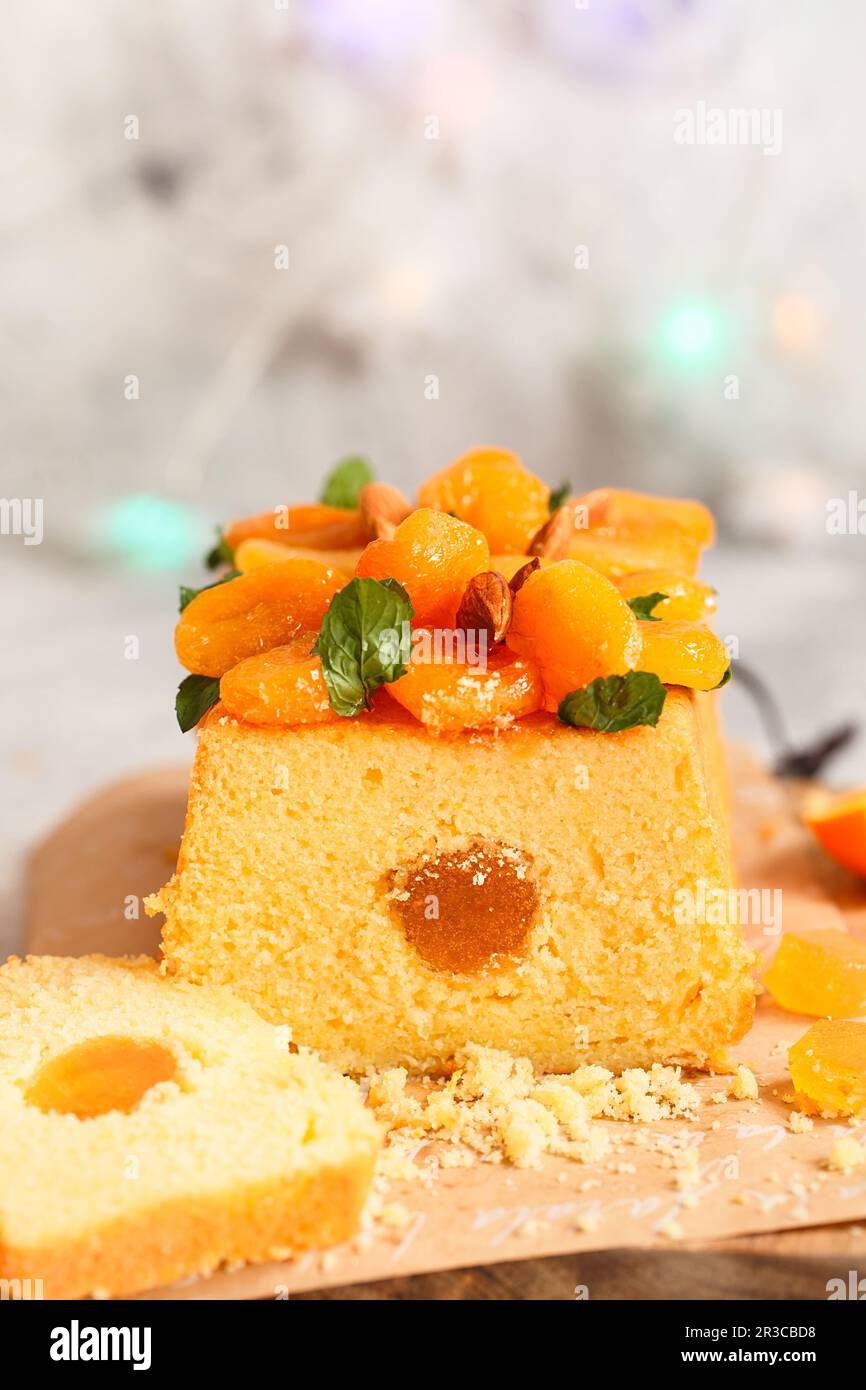 Orange Pound Cake flavored with freshly squeezed orange juice and zest decorated with dried apricots Stock Photo