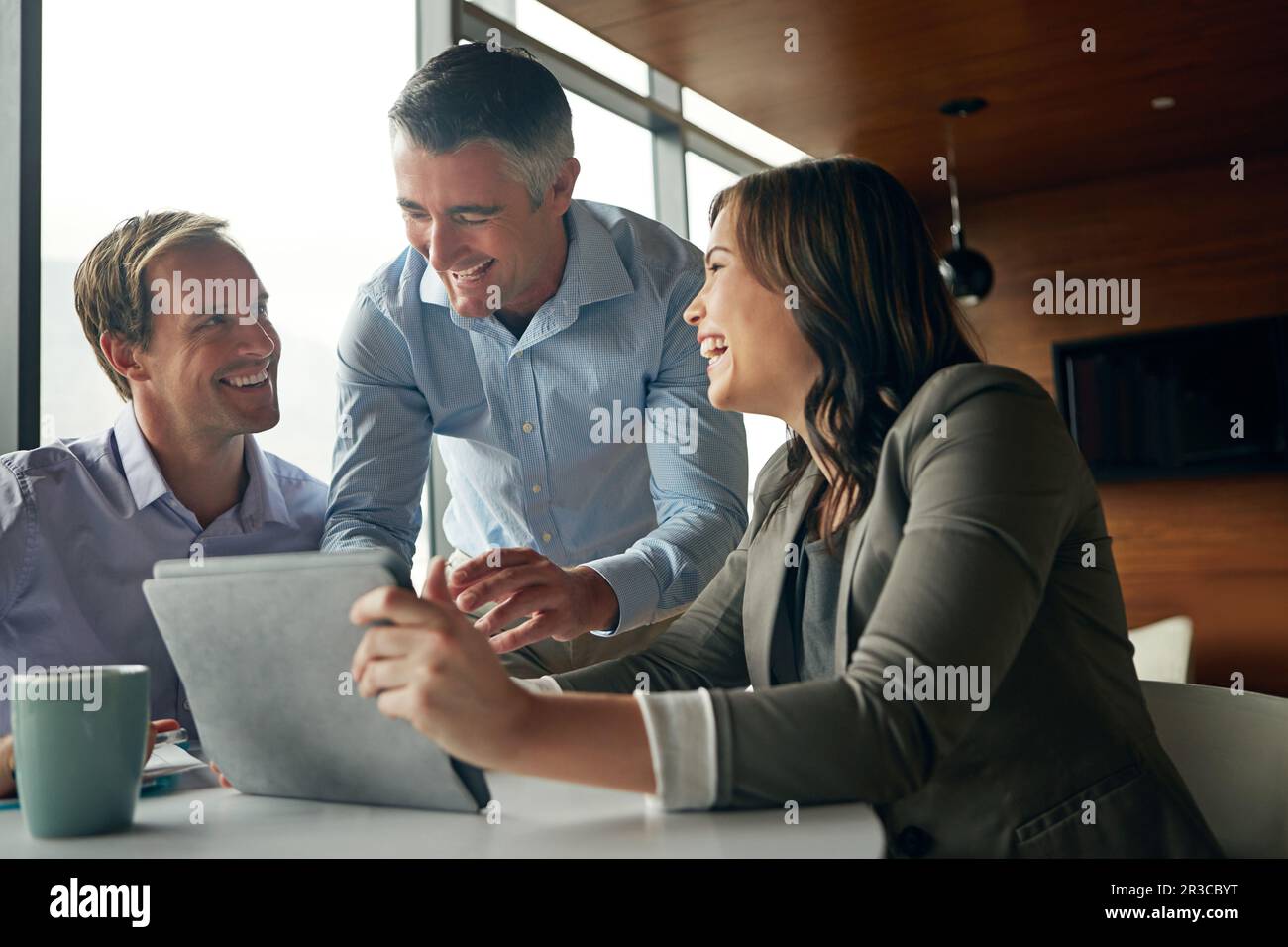 Laughing tablet and business people in meeting for online results Laughing tablet and business people in meeting for online results