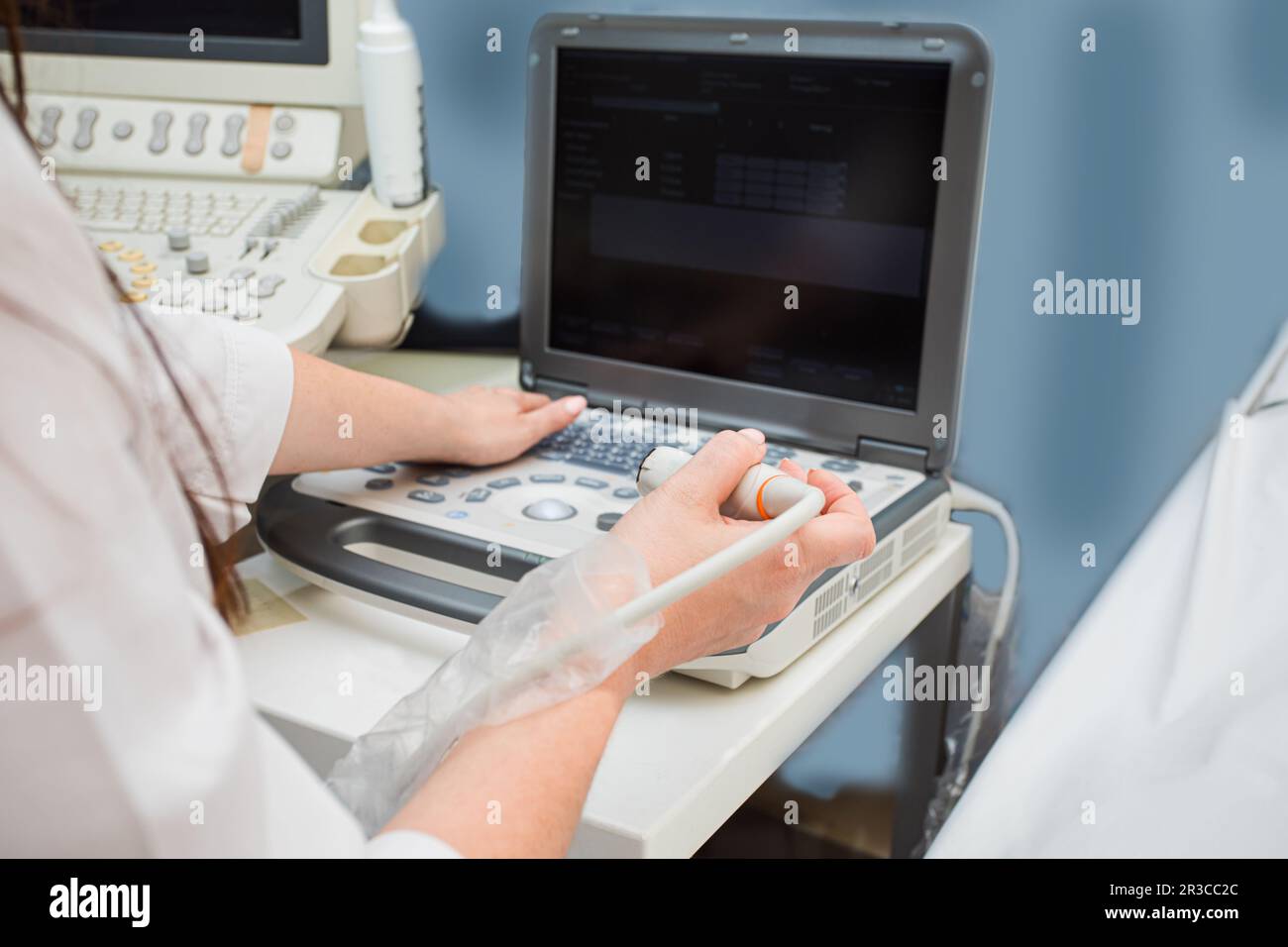 Doctor's hands operating modern portable medical equipment Stock Photo