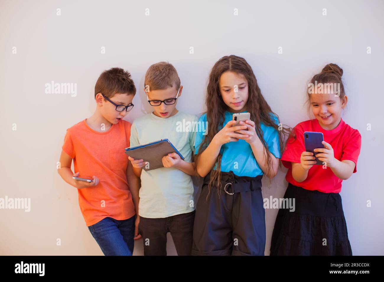 Modern generation feeling happy using smartphones and tablets Stock