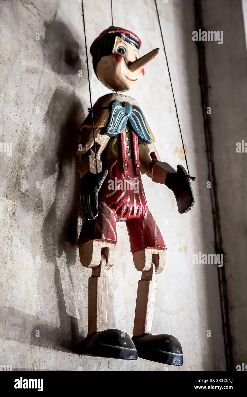 Wooden String Puppet Boy hanging on a wall Stock Photo