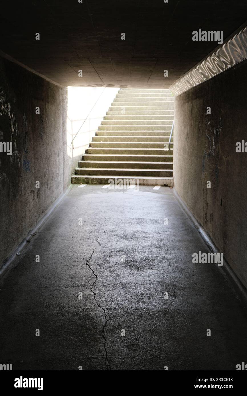 An underpass or tunnel constructed beneath a road or railway, providing a safe passage for pedestrians or vehicles to cross without interference. Stock Photo