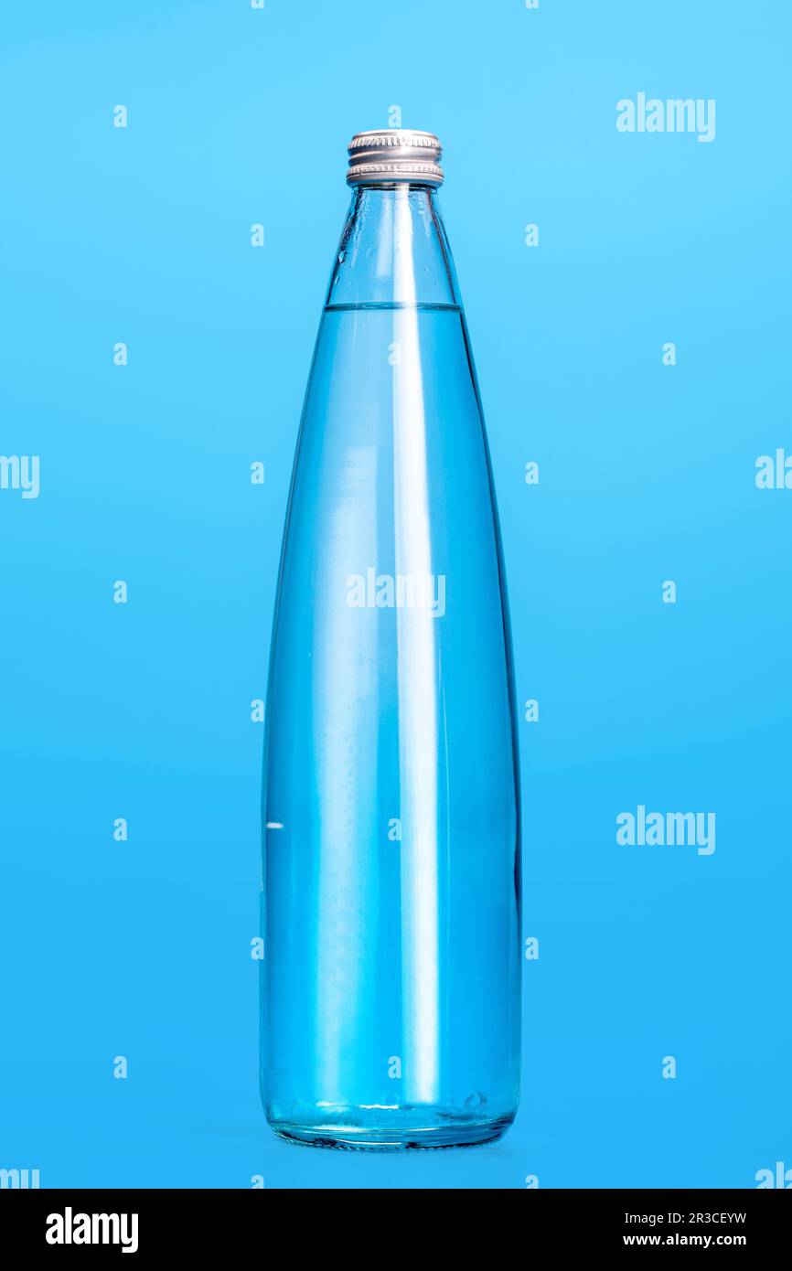 Glass water bottles on a light blue background Stock Photo Alamy