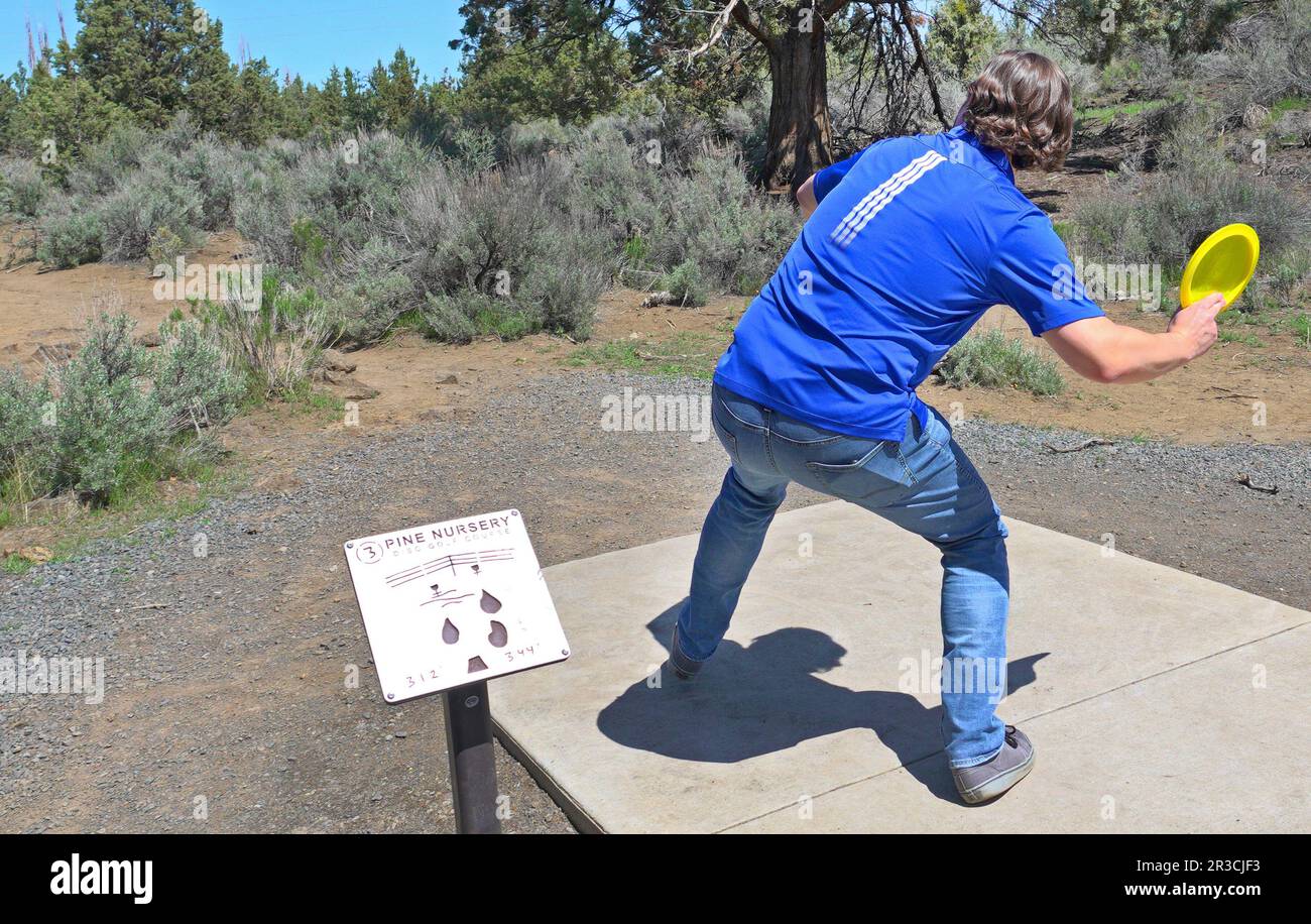 A person playing Disc Golf at the Pine Nursery course in Bend, Oregon. Stock Photo