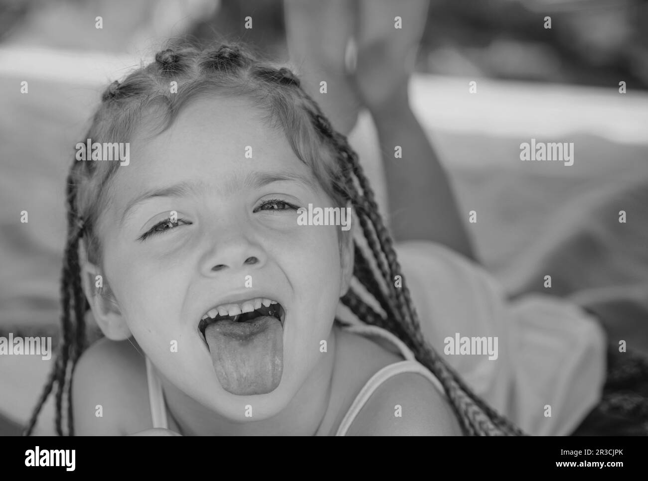 Girl tongue out. Having fun outdoors. Campground. Smiling adorable kid