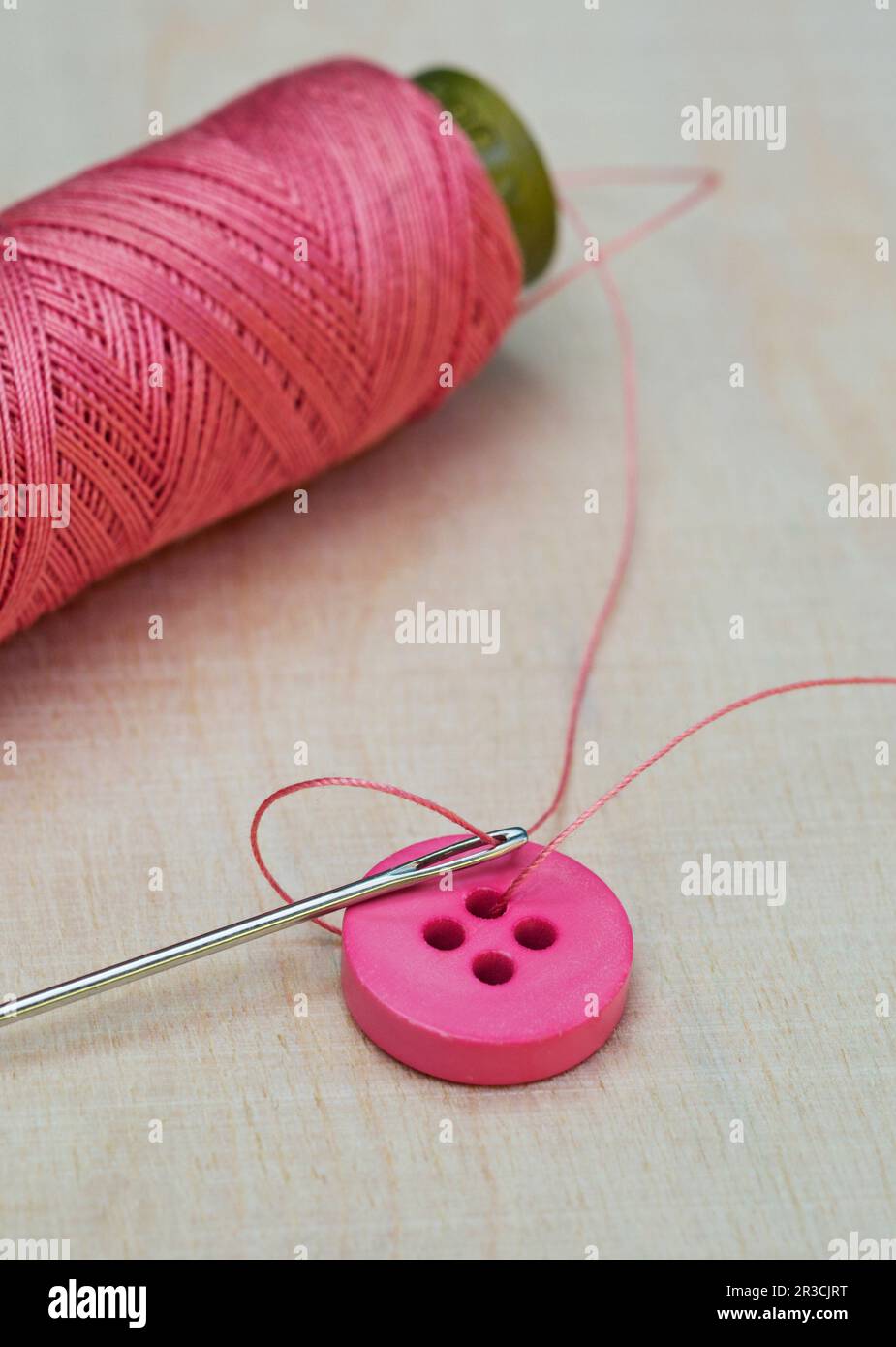 spool of thread, needle and button Stock Photo