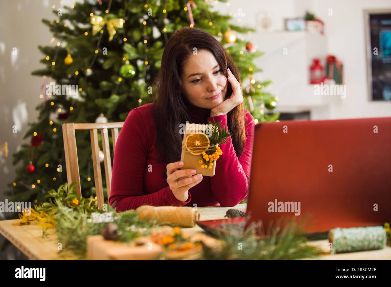 Sad woman shows her relatives, how she packing gifts Stock Photo