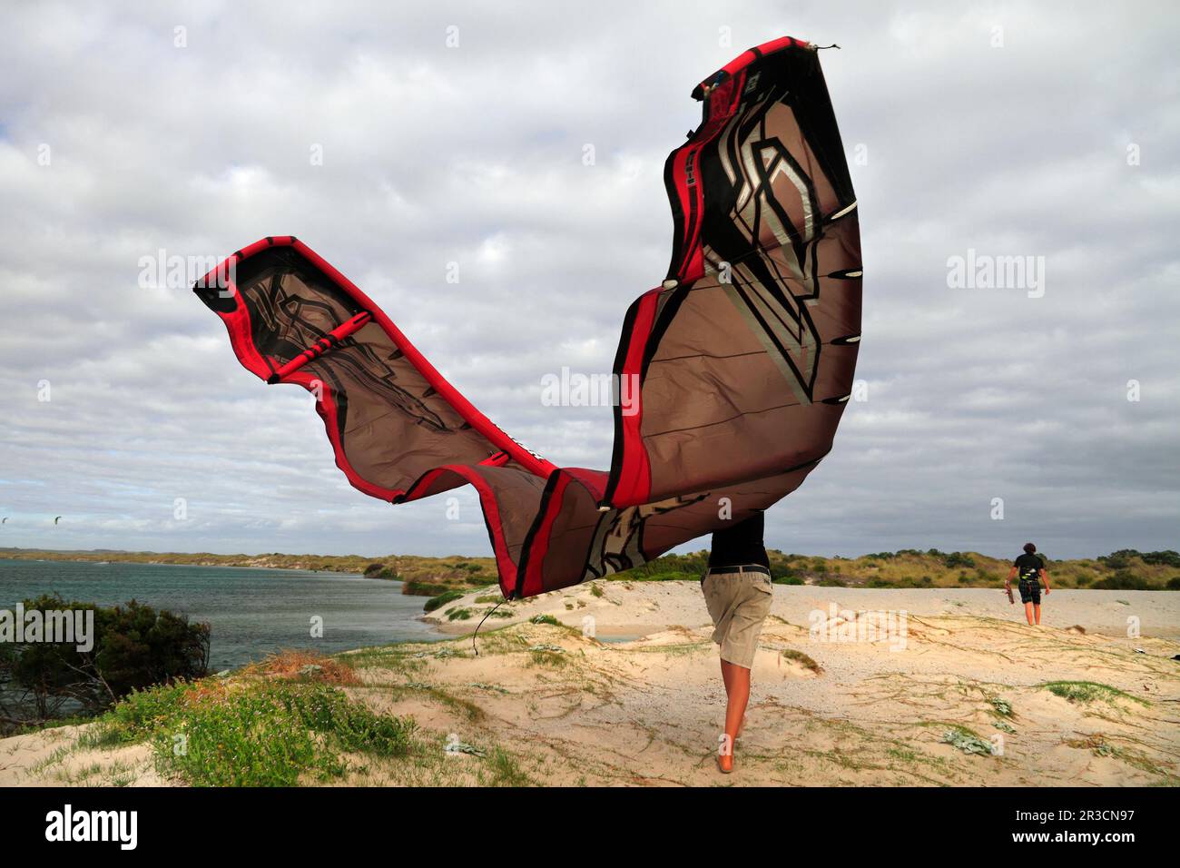 Young woman walking on foreshore with surf  kite at,  Augusta, Southwest Australia Stock Photo