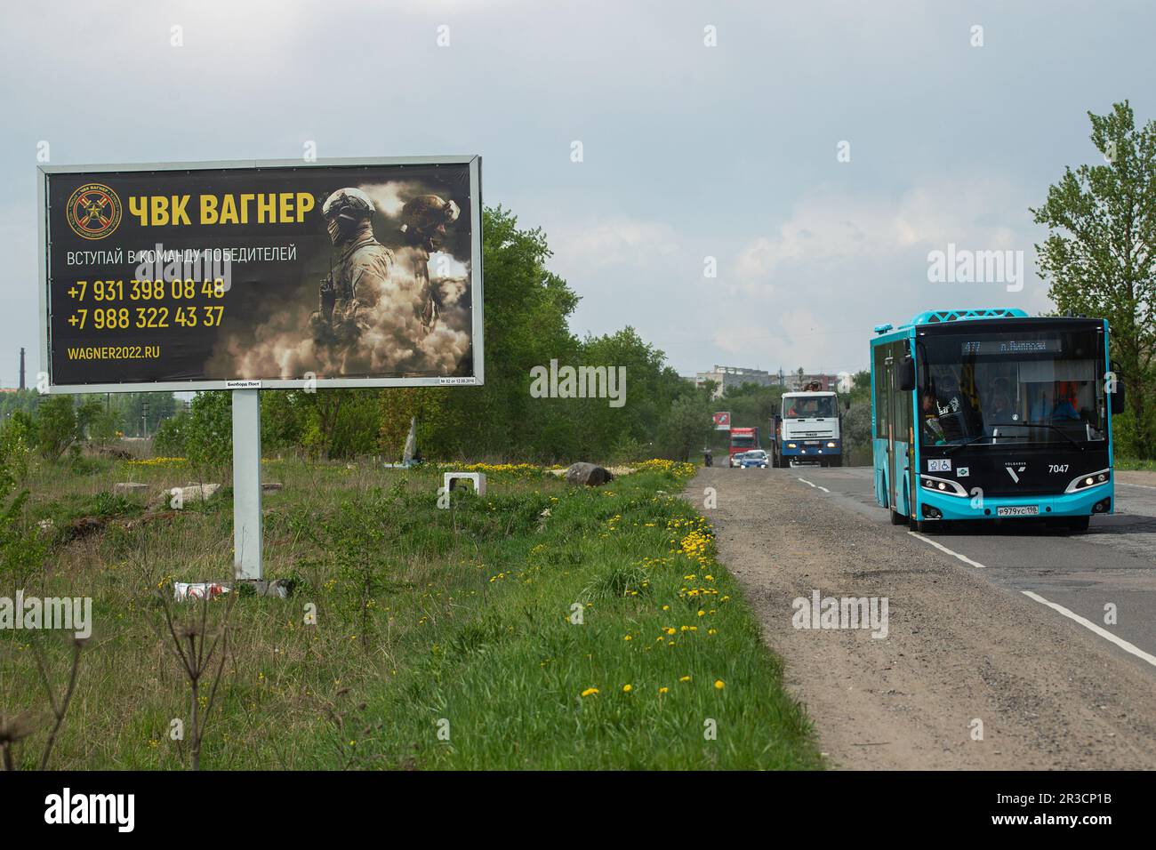 A bus drives along a highway past a billboard near St. Petersburg in the Leningrad Region depicting Russian servicemen and an advertisement for a private military company, PMC Wagner, with the inscription 'Join the winning team'. On May 20, 2023, the founder of a private military company, Yevgeny Prigozhin, made a statement that the PMC Wagner group had completely taken the city of Bakhmut under its control. Stock Photo