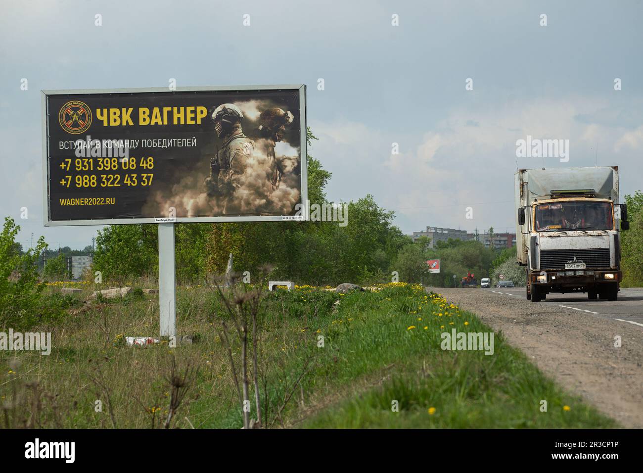 A truck drives past a billboard on a highway near St. Petersburg in the Leningrad Region depicting Russian servicemen and an advertisement for a private military company, PMC Wagner, with the inscription 'Join the winning team'. On May 20, 2023, the founder of a private military company, Yevgeny Prigozhin, made a statement that the PMC Wagner group had completely taken the city of Bakhmut under its control. Stock Photo