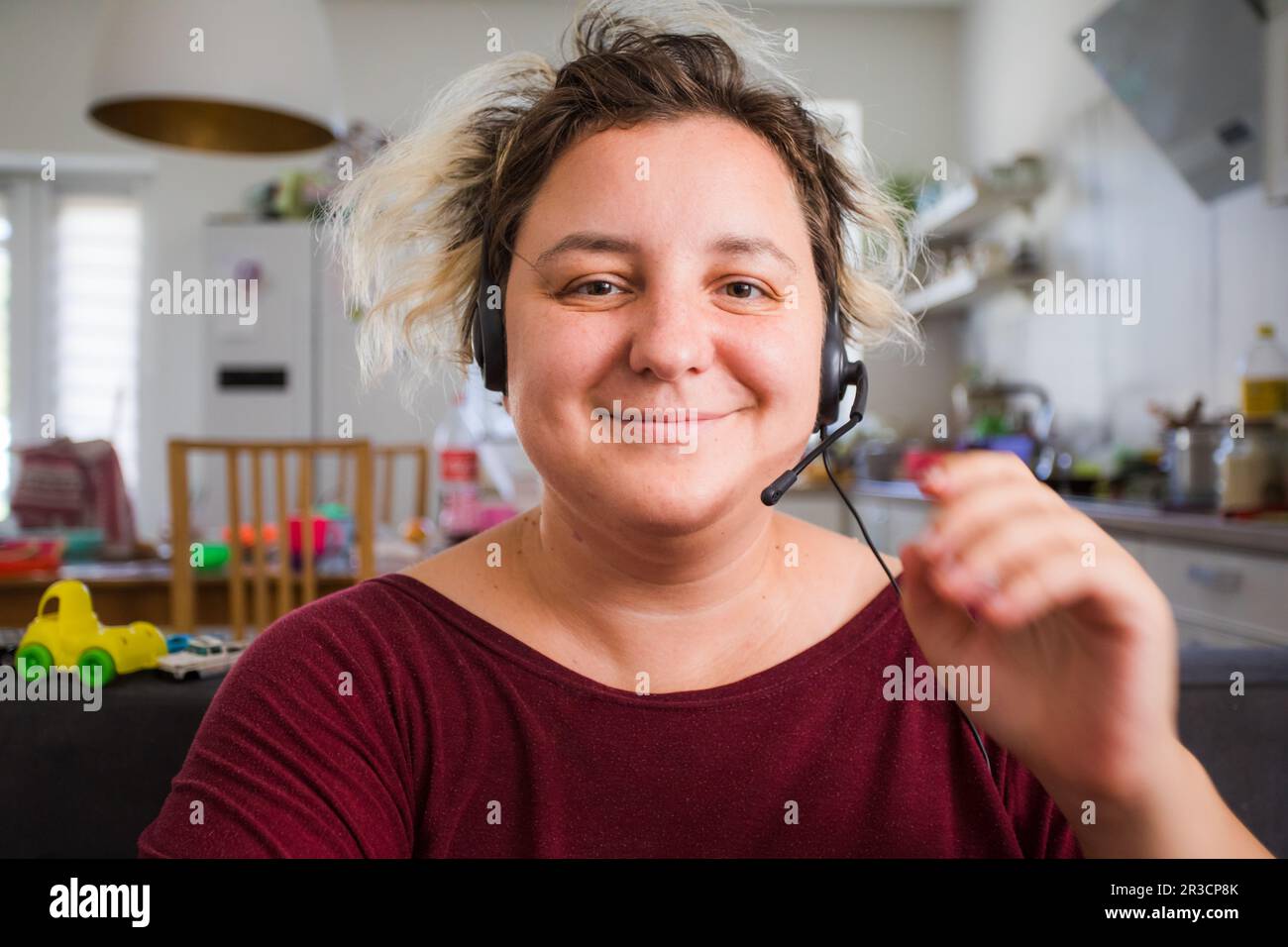 Woman combining remote work and raising kids Stock Photo