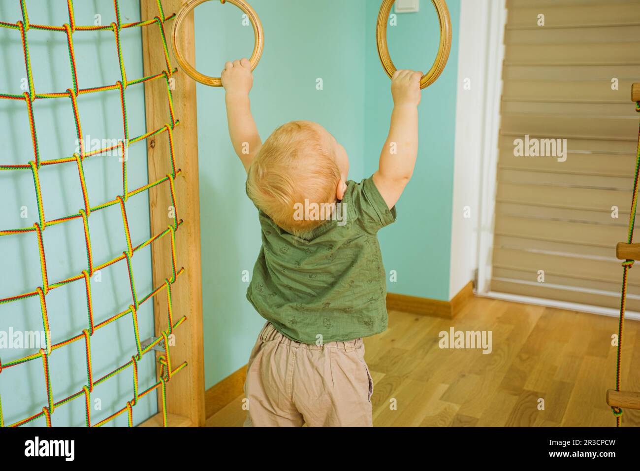 The toddler doing physical exercises in the gym Stock Photo Alamy