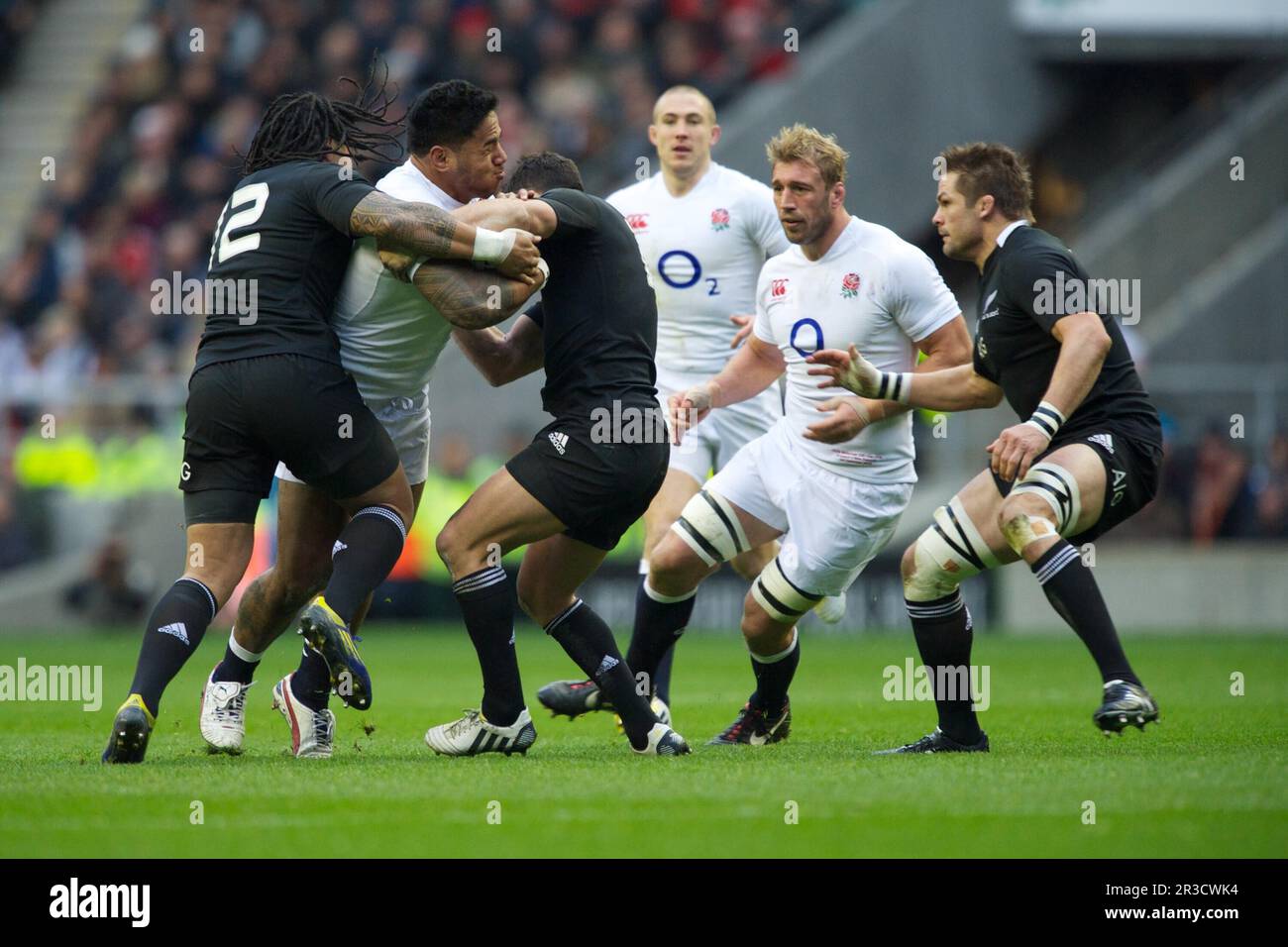 Manu Tuilagi of England is tackled by Ma'a Nonu of New Zealand during the QBE Autumn International match between England and New Zealand at Twickenham Stock Photo