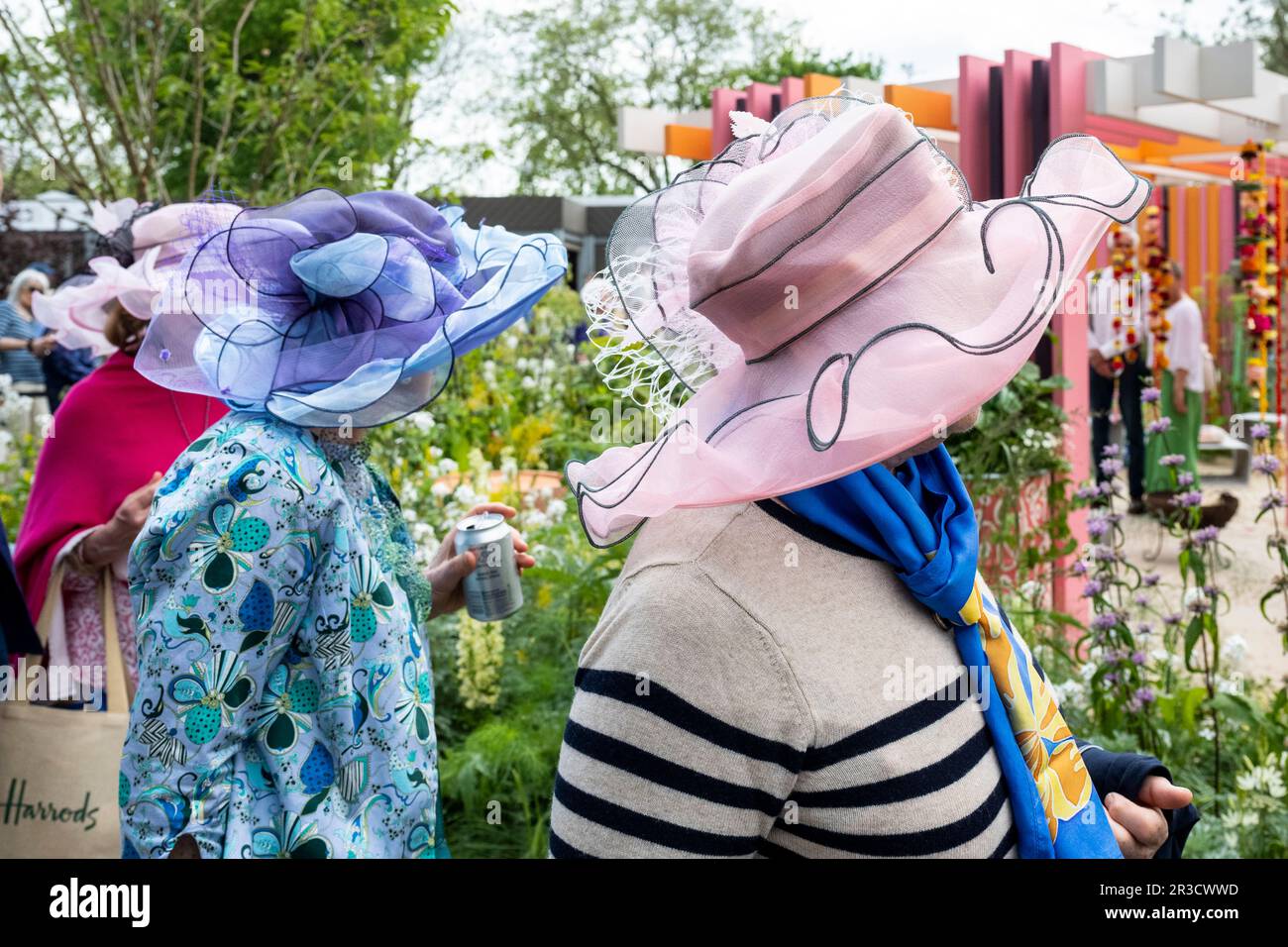 London UK. 23 May 2023. Women in floral hats queue to view a show