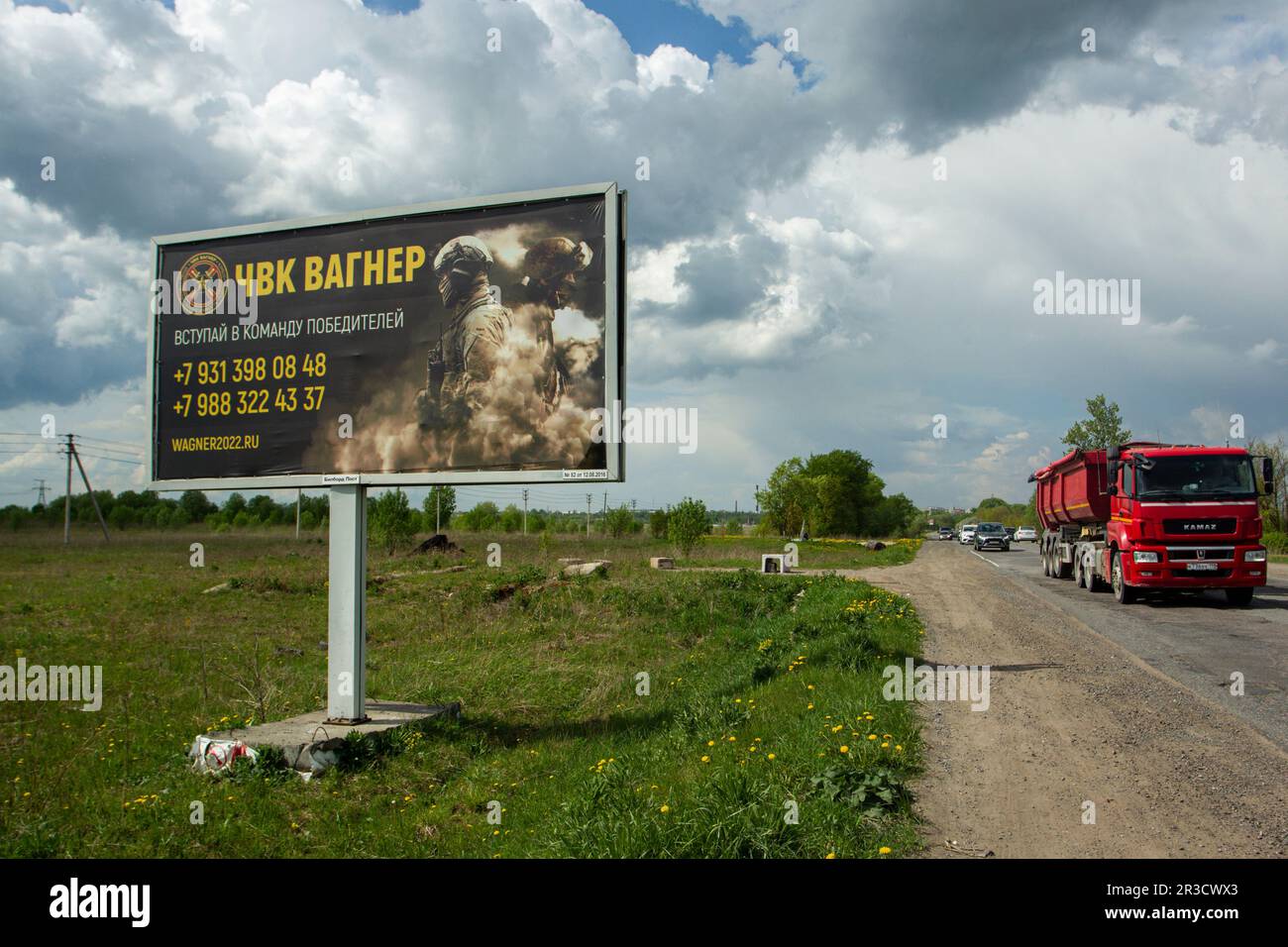 Saint Petersburg, Russia. 22nd May, 2023. A dump truck drives past a billboard on a highway near St. Petersburg in the Leningrad Region depicting Russian servicemen and an advertisement for a private military company, PMC Wagner, with the inscription ''Join the winning team''. On May 20, 2023, the founder of a private military company, Yevgeny Prigozhin, made a statement that the PMC Wagner group had completely taken the city of Bakhmut under its control. (Credit Image: © Artem Priakhin/SOPA Images via ZUMA Press Wire) EDITORIAL USAGE ONLY! Not for Commercial USAGE! Stock Photo